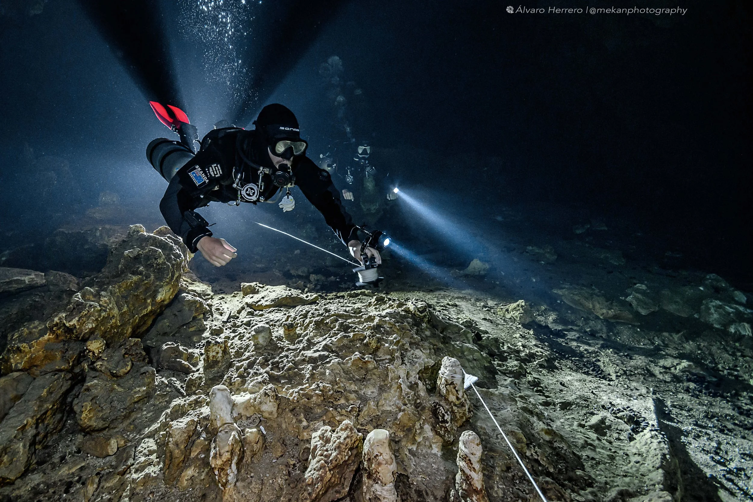 Cave Divers connecting their reel to the main cave line