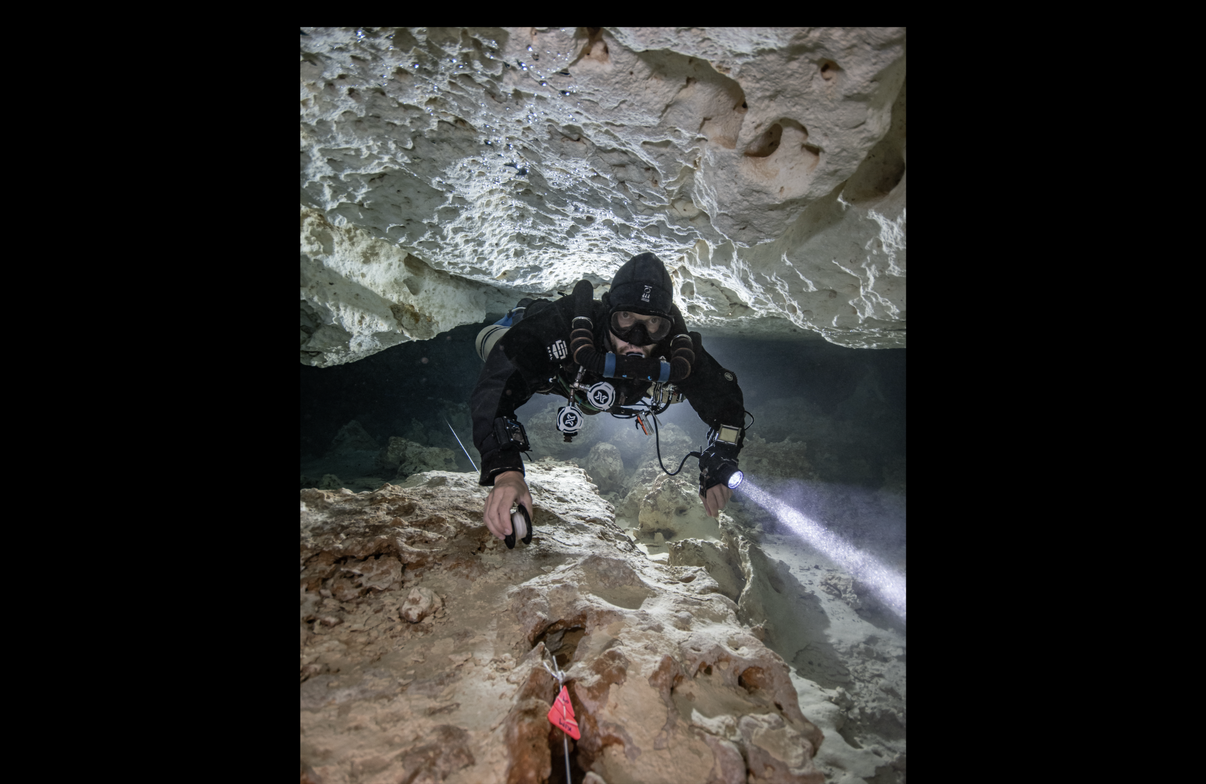 Skanda Coffield-Feith jumping to a side passage while using a canister light