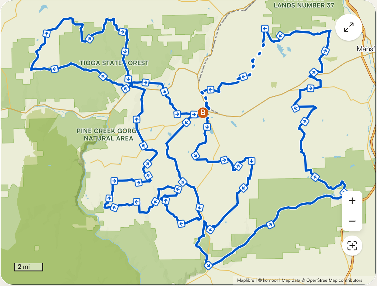 Map showing hiking trails in Tioga State Forest and Pine Creek Gorge Natural Area with blue trail lines and directional arrows.