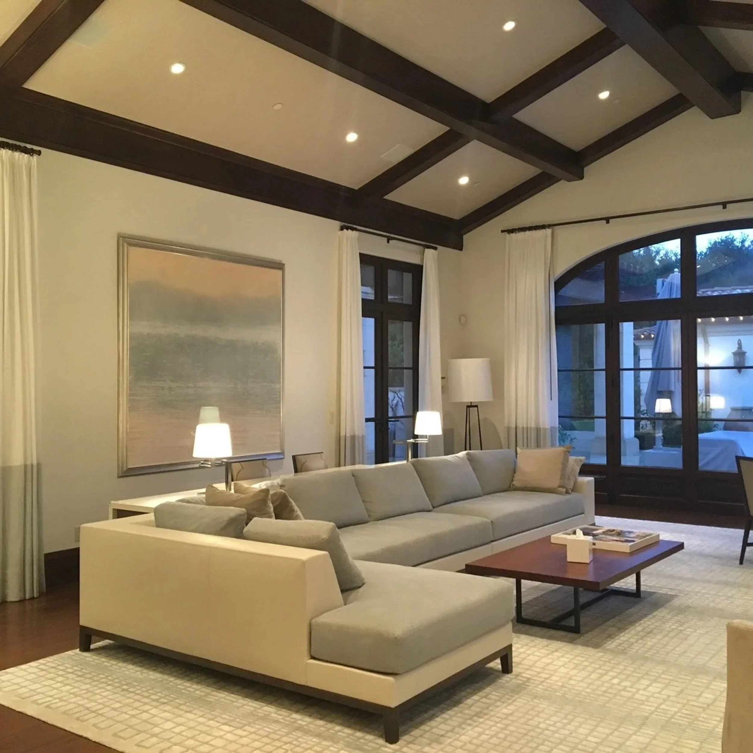 Abstract artwork placed above the sectional sofa in a living room.