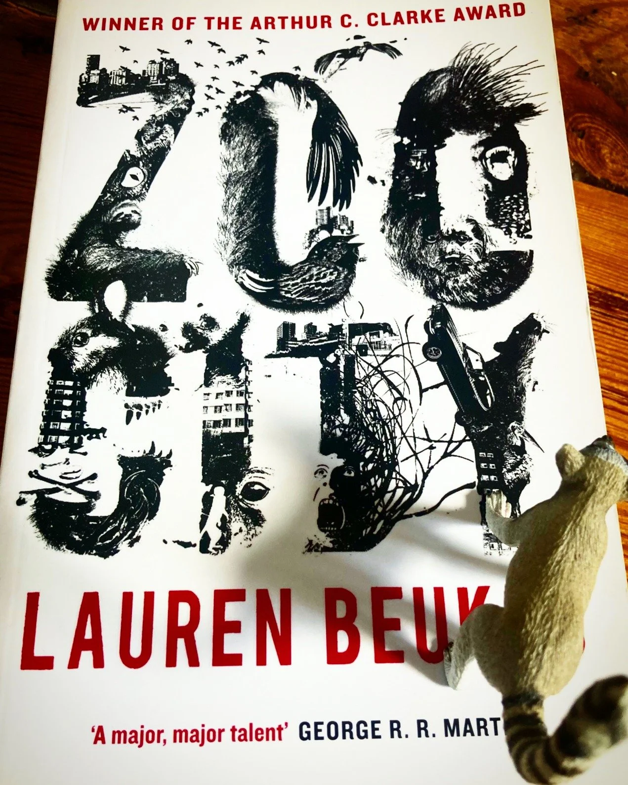 Some blurbs hint. 

Originally published by @angryrobotbooks this @michaeljbooks &amp; @penguinukbooks edition of @laurenbeukes @clarkeaward winning Zoo City still features the original pbk cover and blurb.

The book's big weird involves criminals be