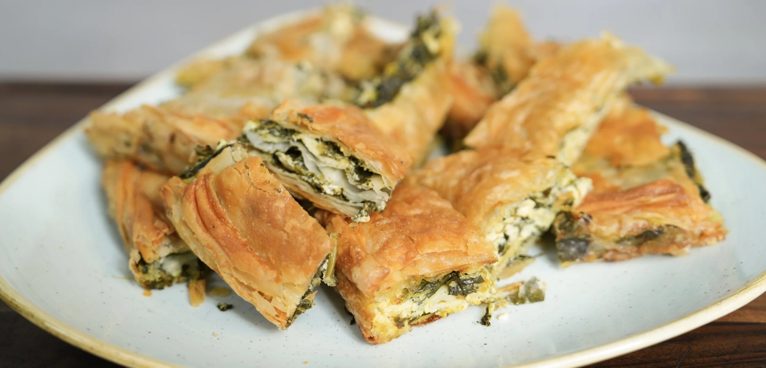 Plate of spinach and cheese pastry slices