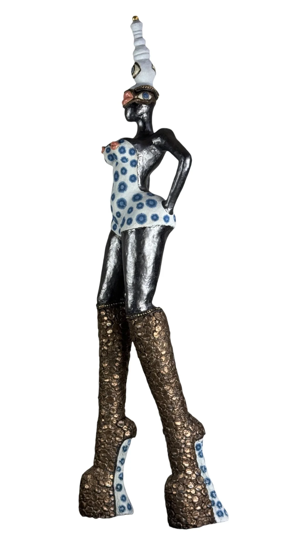 contemporary ceramic figurative sculpture of a woman with eyes and mouths distributed across the body, sides, and hat, a mouth  partly covering the face, and a dress with blue viruslike floral forms.