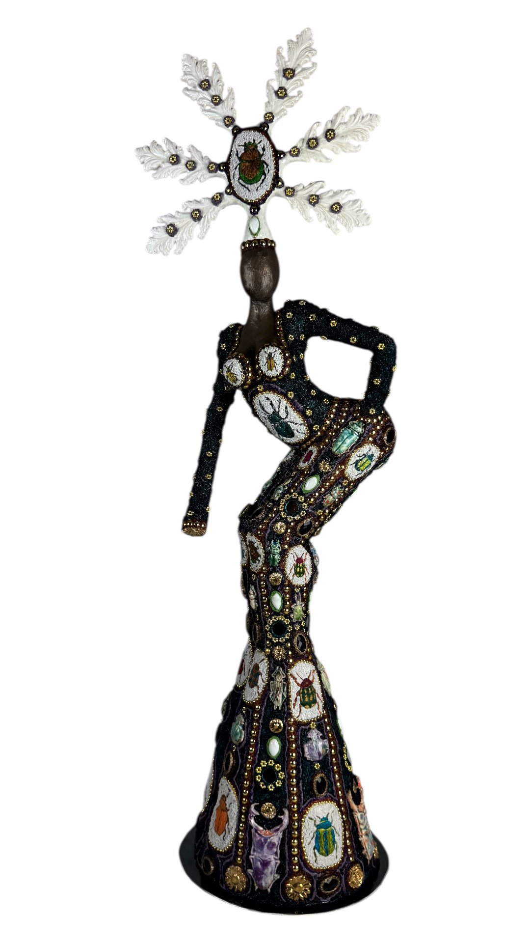 Figurative contemporary sculpture of a female guardian figure, incorporating hand-embroidered beetles and insect motifs, made with recycled and found materials, referencing memory, loss, and vanshied insect life.