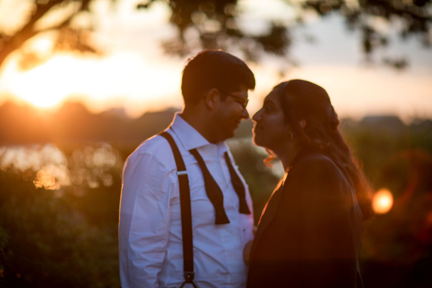 a couple taking engagement photos at the jefferson memorial at sunset
