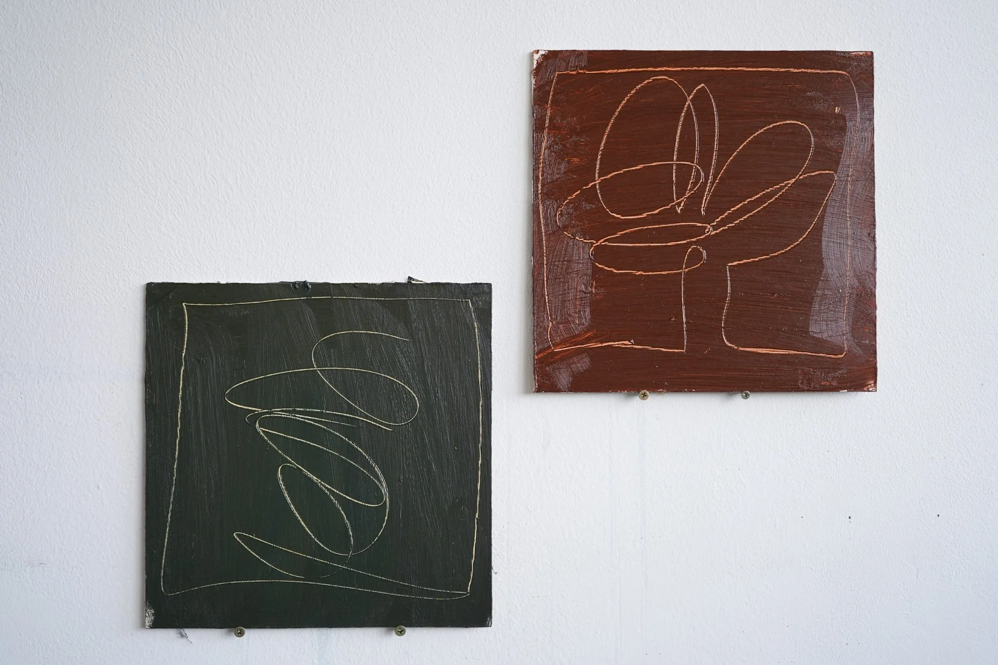 Two abstract, minimalist paintings on canvas with swirling line designs, mounted on a white wall.