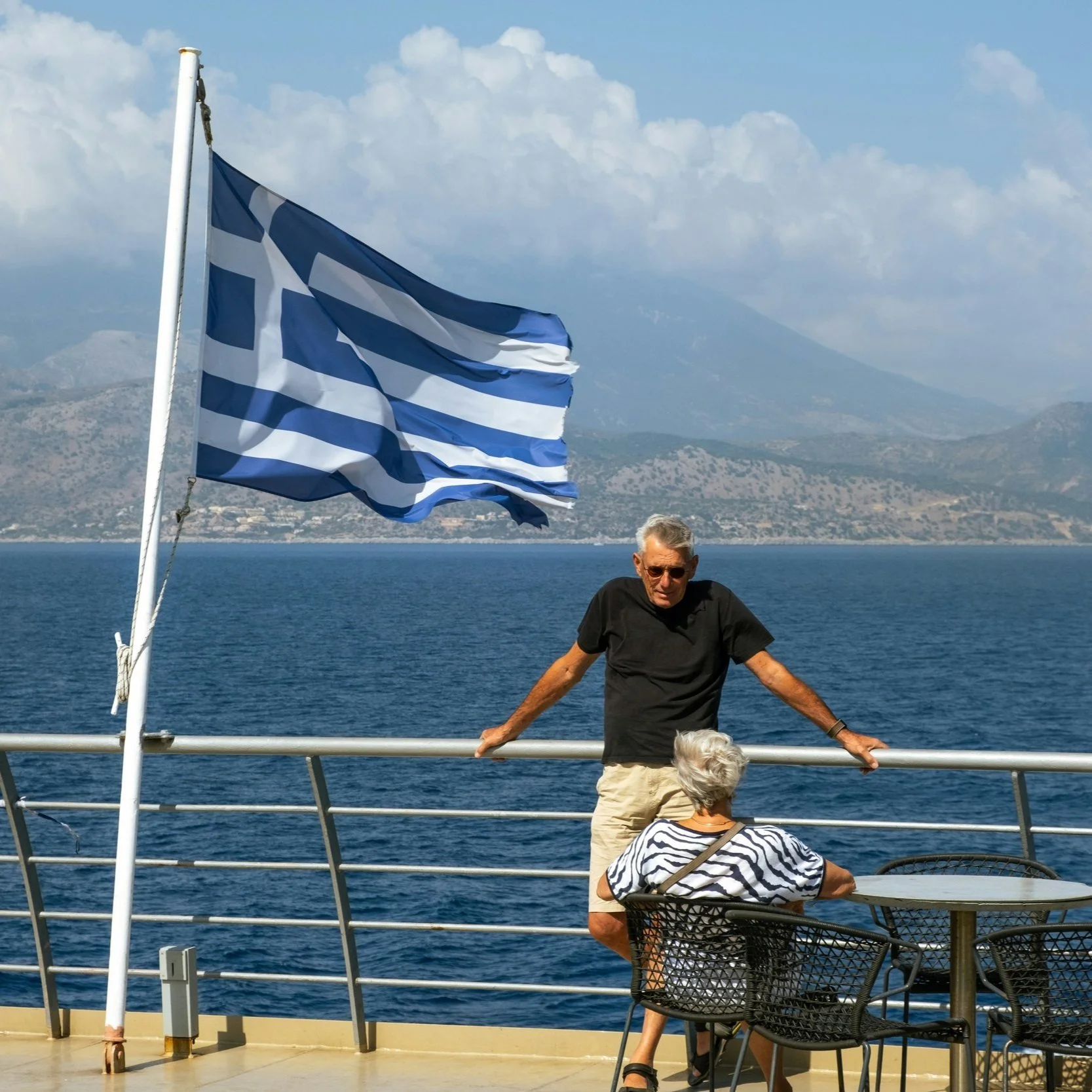 On a boat between islands, Greek flag waving—retreat days that stretch beyond the shoreline