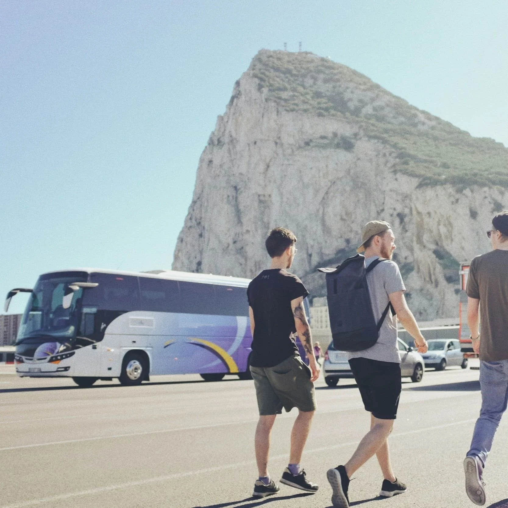 People Walking in Greek Sun Outside Tourbus