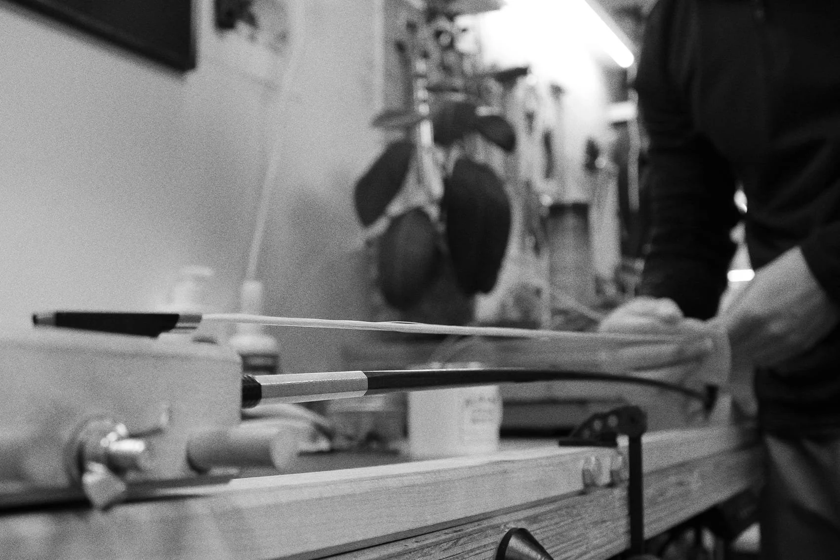 A violin bow rehair, having new bow hair installed