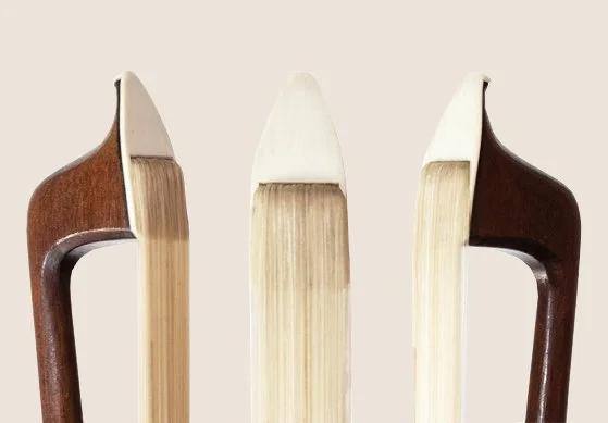 Close-up of three different angles of a new violin bow face/headplate