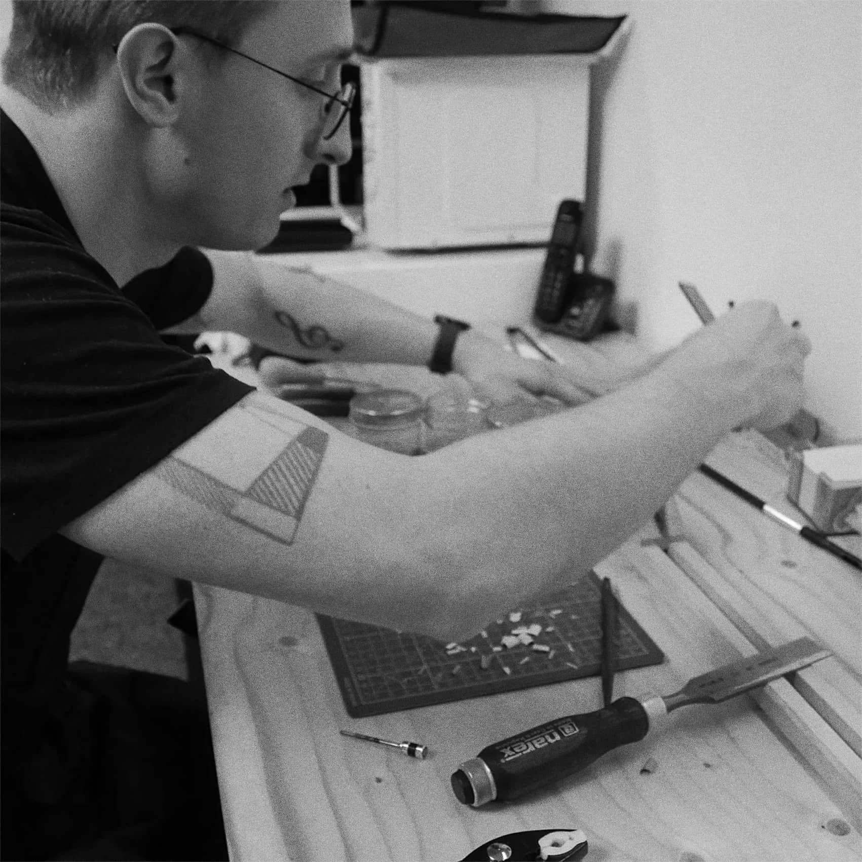 A person working on a violin bow during the rehair process