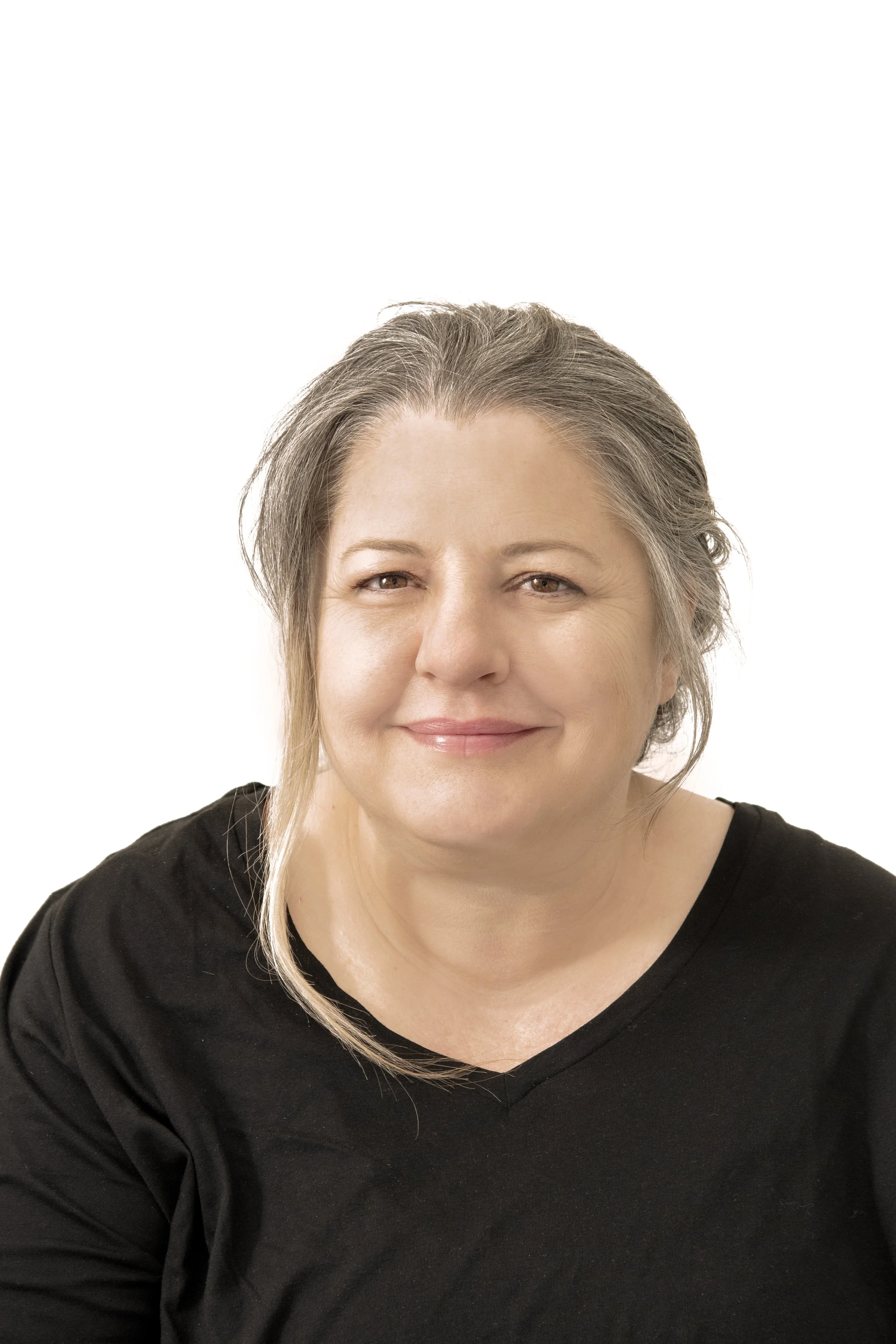 A middle-aged woman with gray hair, smiling and wearing a black shirt against a white background.