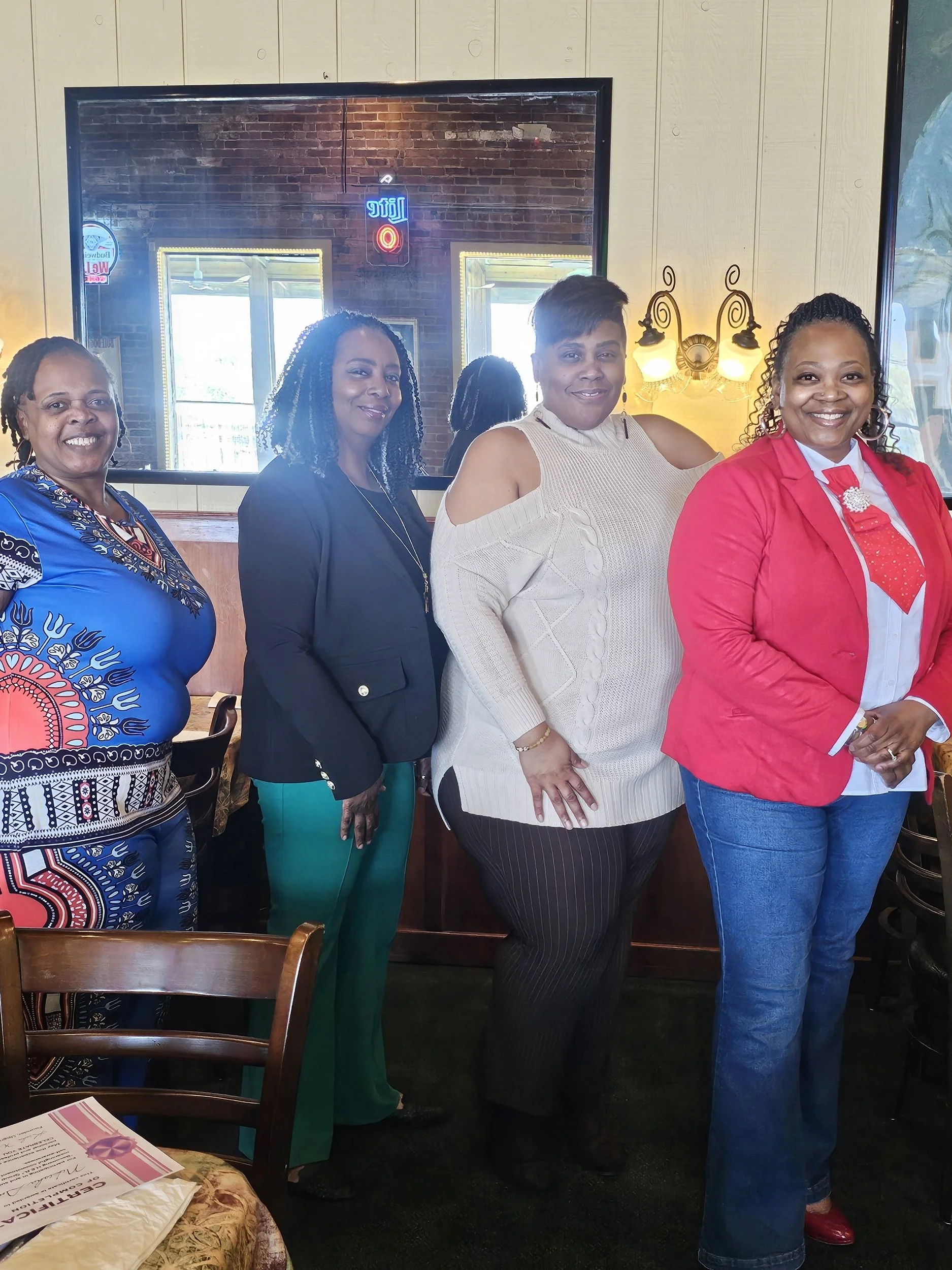 Four Women  at a restaurant celebrating a completion of a coaching program from Upgraded MindsetZ