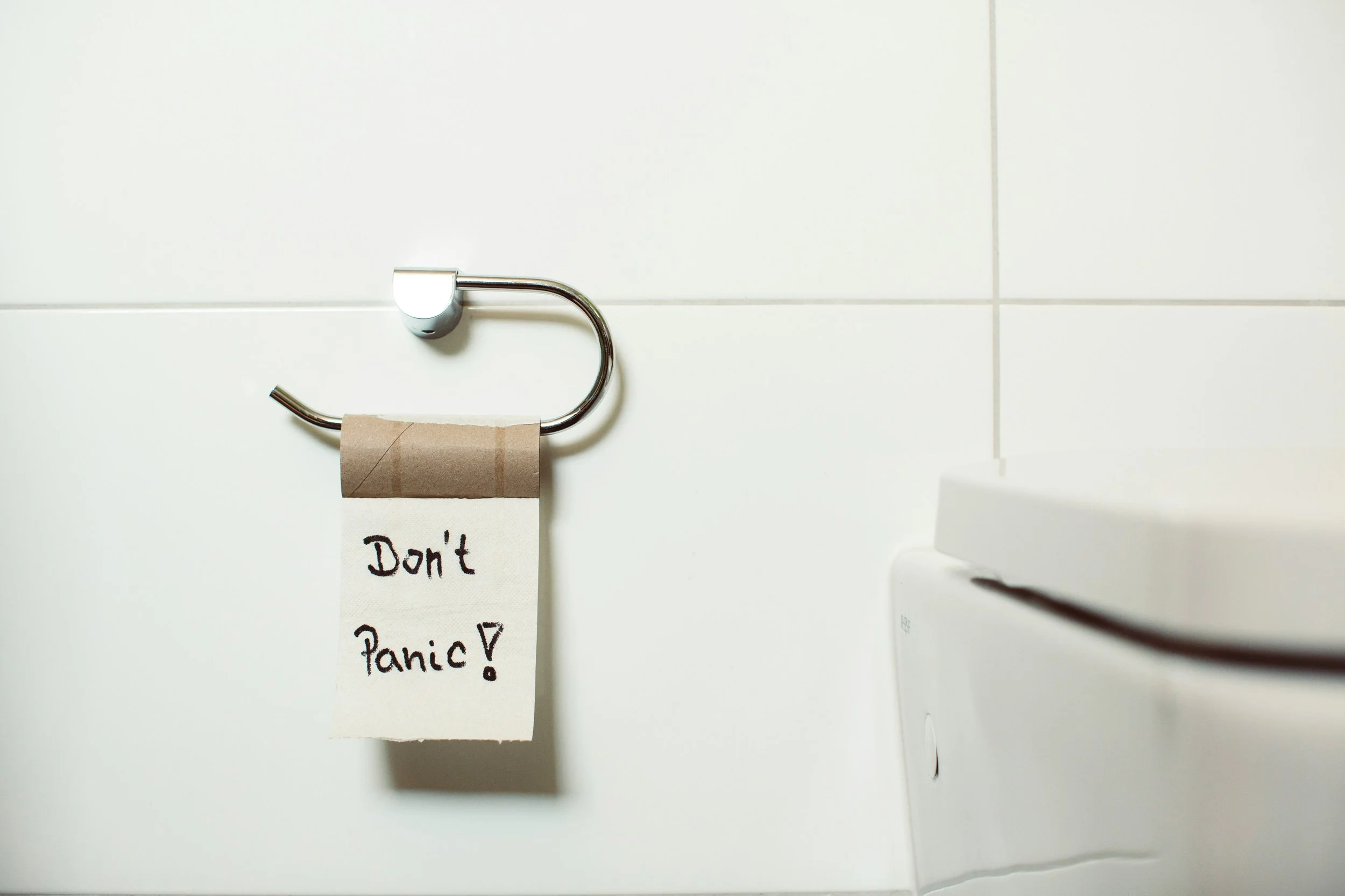 A sanitary hook with a note that says 'Don't Panic!'