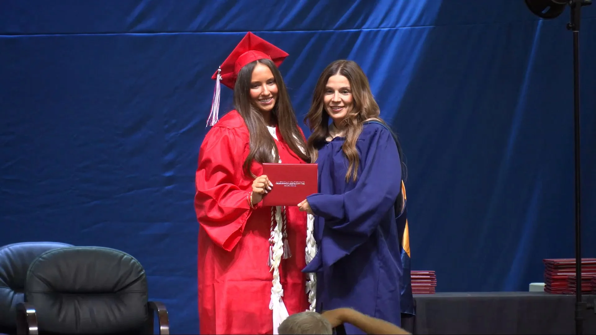 Graduation livestreaming capturing a diploma presentation at an East Valley school ceremony