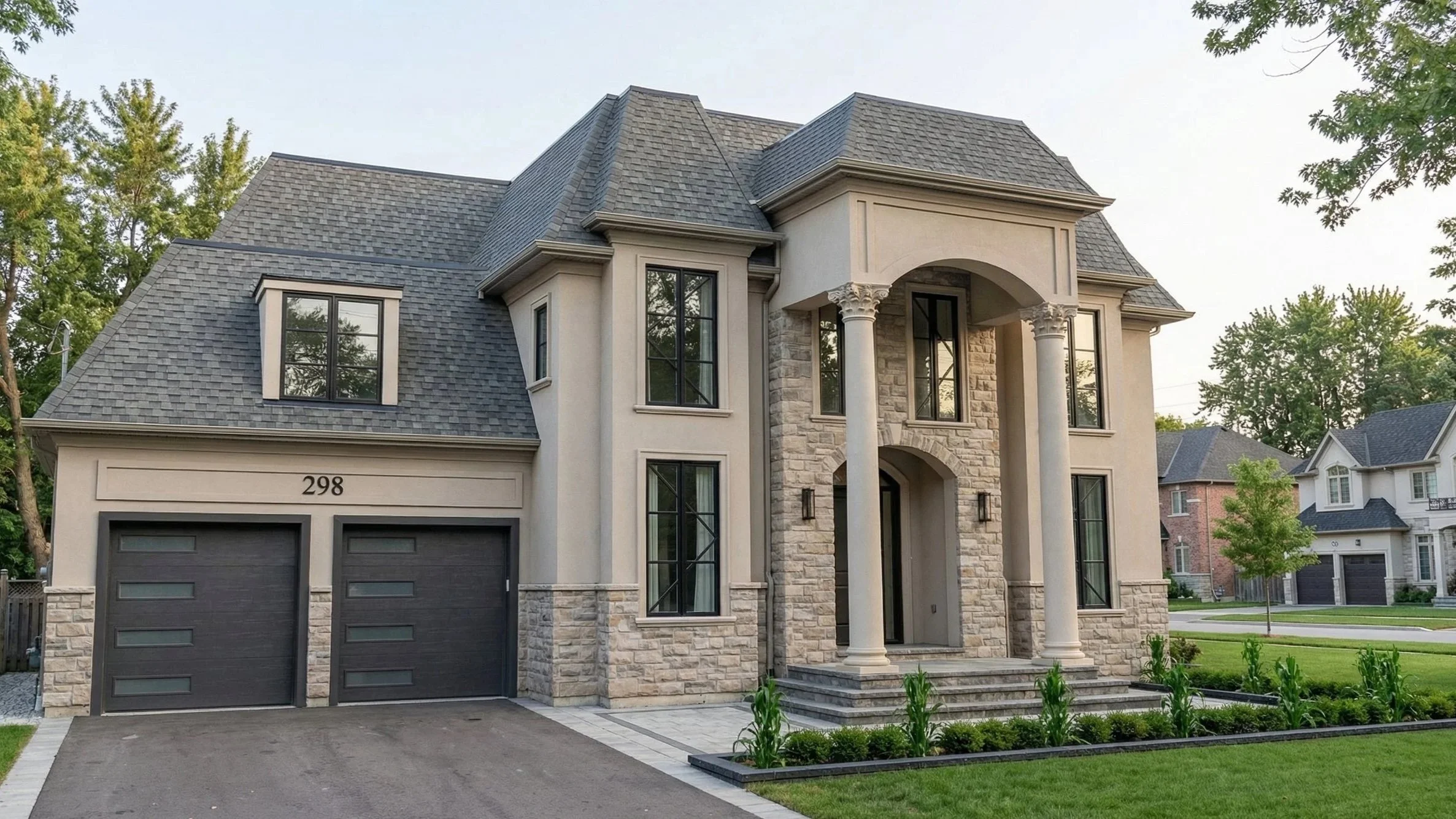 Modern French Provincial custom home exterior designed by Dar Architects Inc., featuring a luxury stone and stucco facade, grand arched entryway with Corinthian columns, mansard roof, and contemporary black-frame windows with a two-car garage.