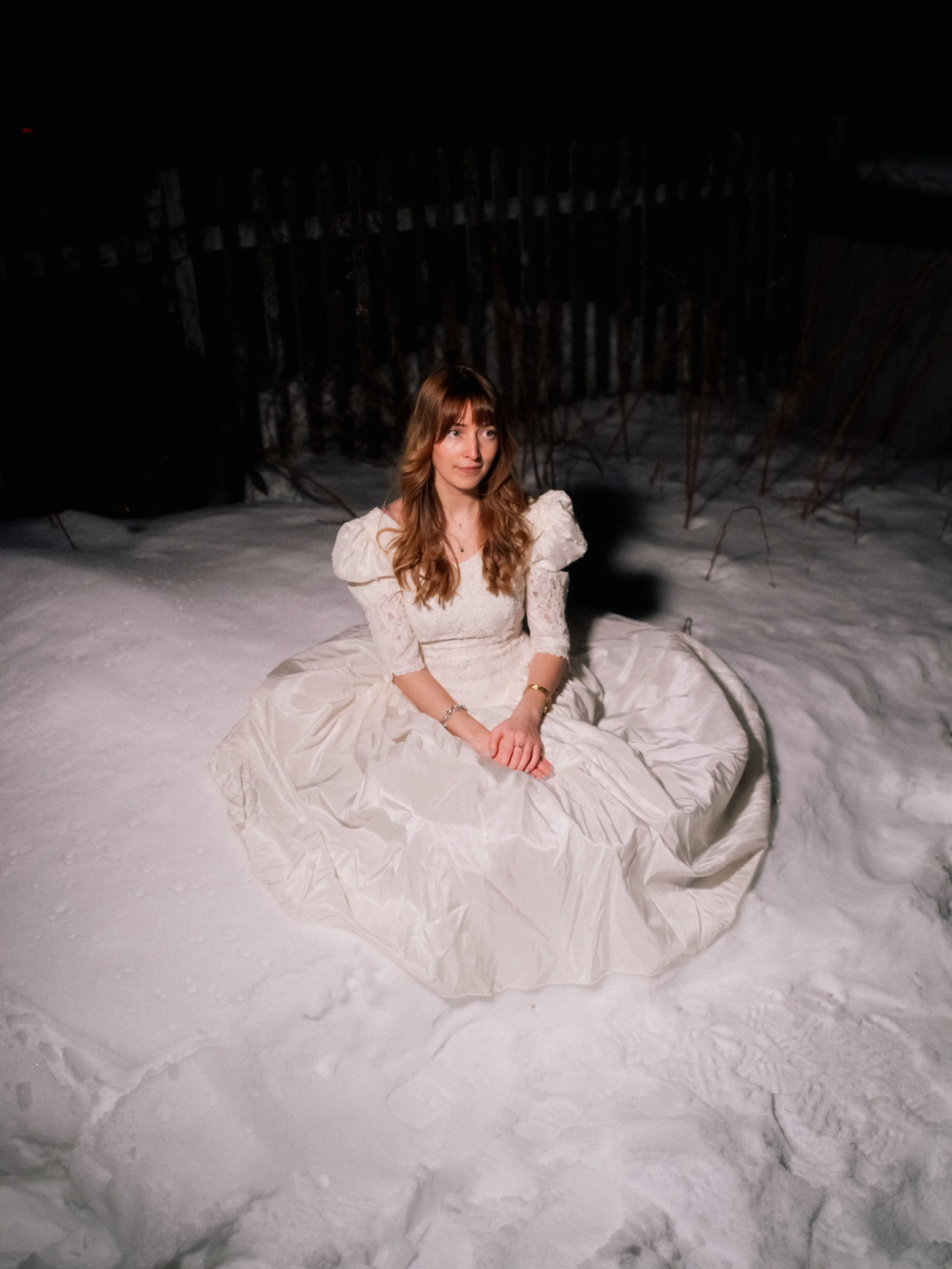 Sadie Skinner sitting on the snow. Sadie Skinner is a folk artist from Halifax, Nova Scotia.
