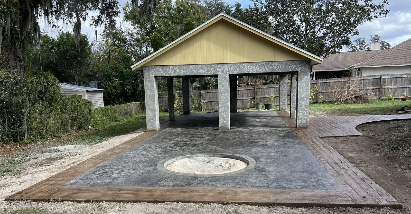Stamped concrete pavilion slab with wood-plank border by Cement-Scapes