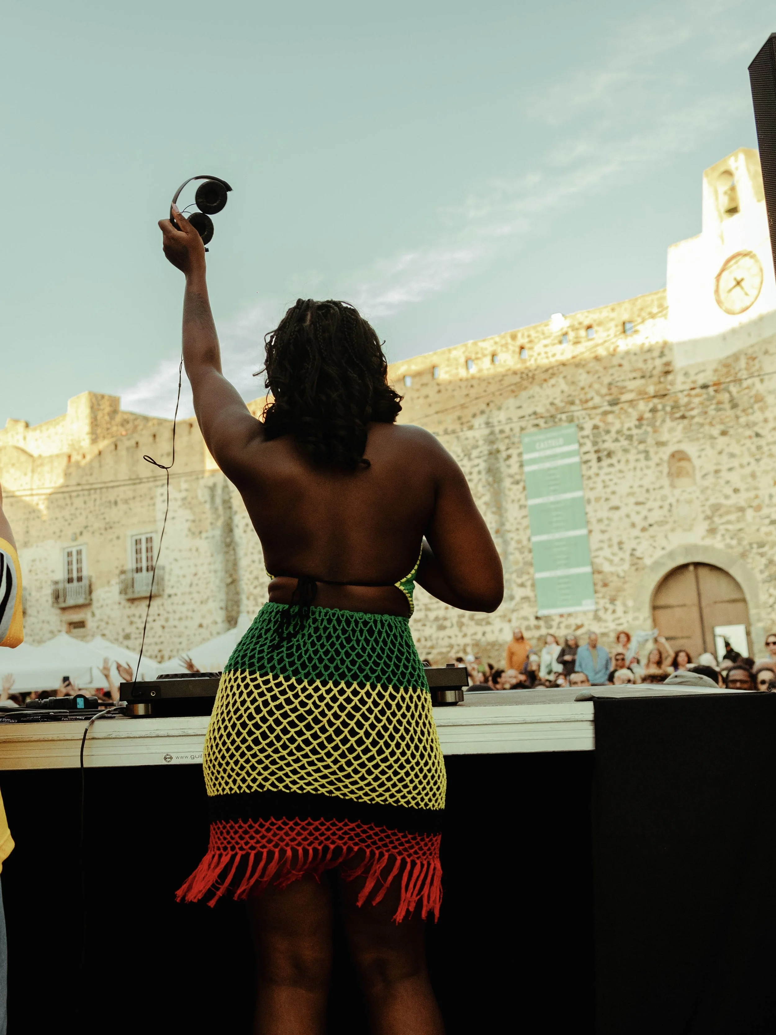 UMAFRICANA performing live at FMM Sines festival, captured from behind with the crowd energy in the background.