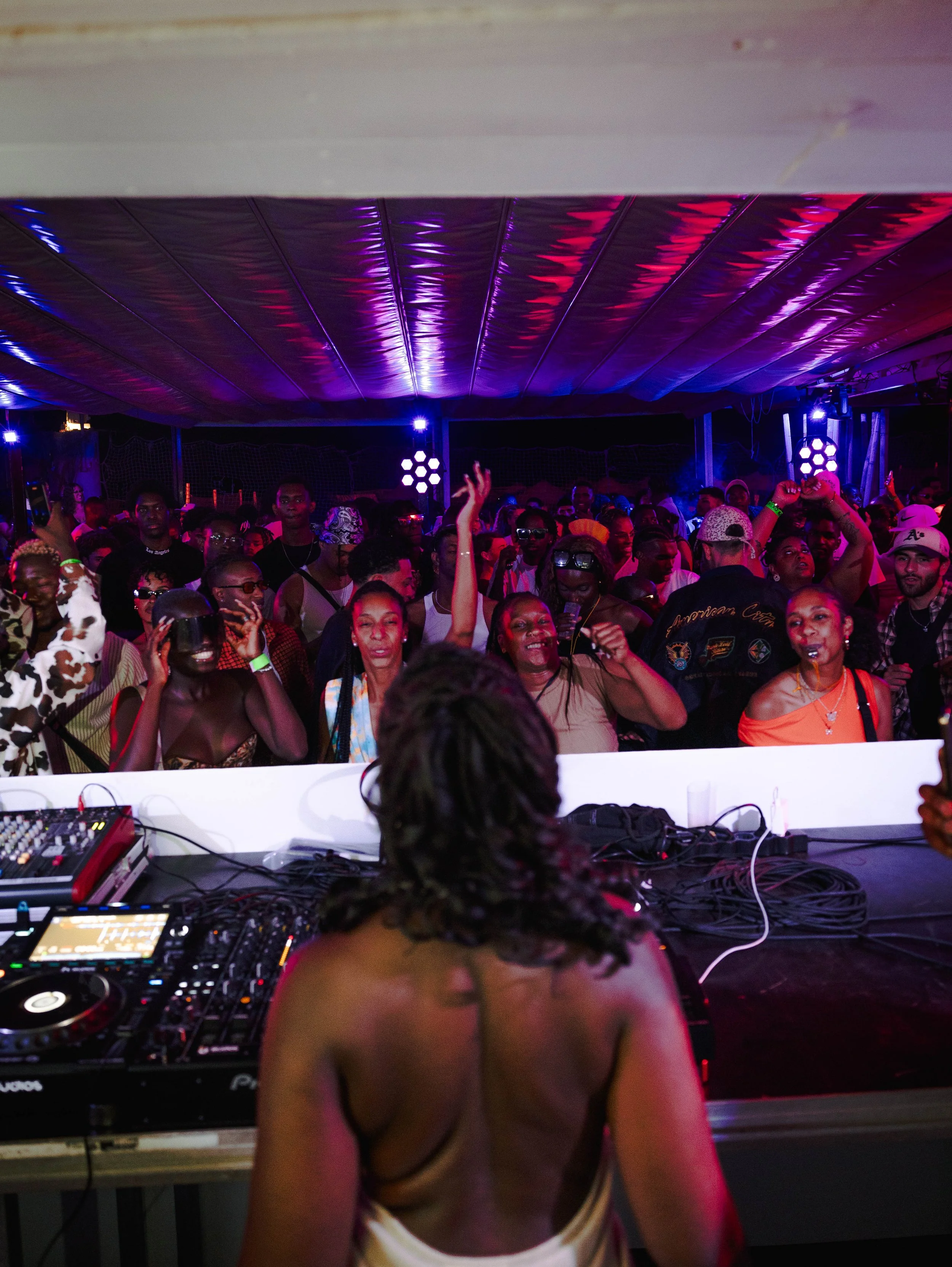 Energetic crowd dancing during an Amapiano event in Costa da Caparica, with UMAFRICANA performing.