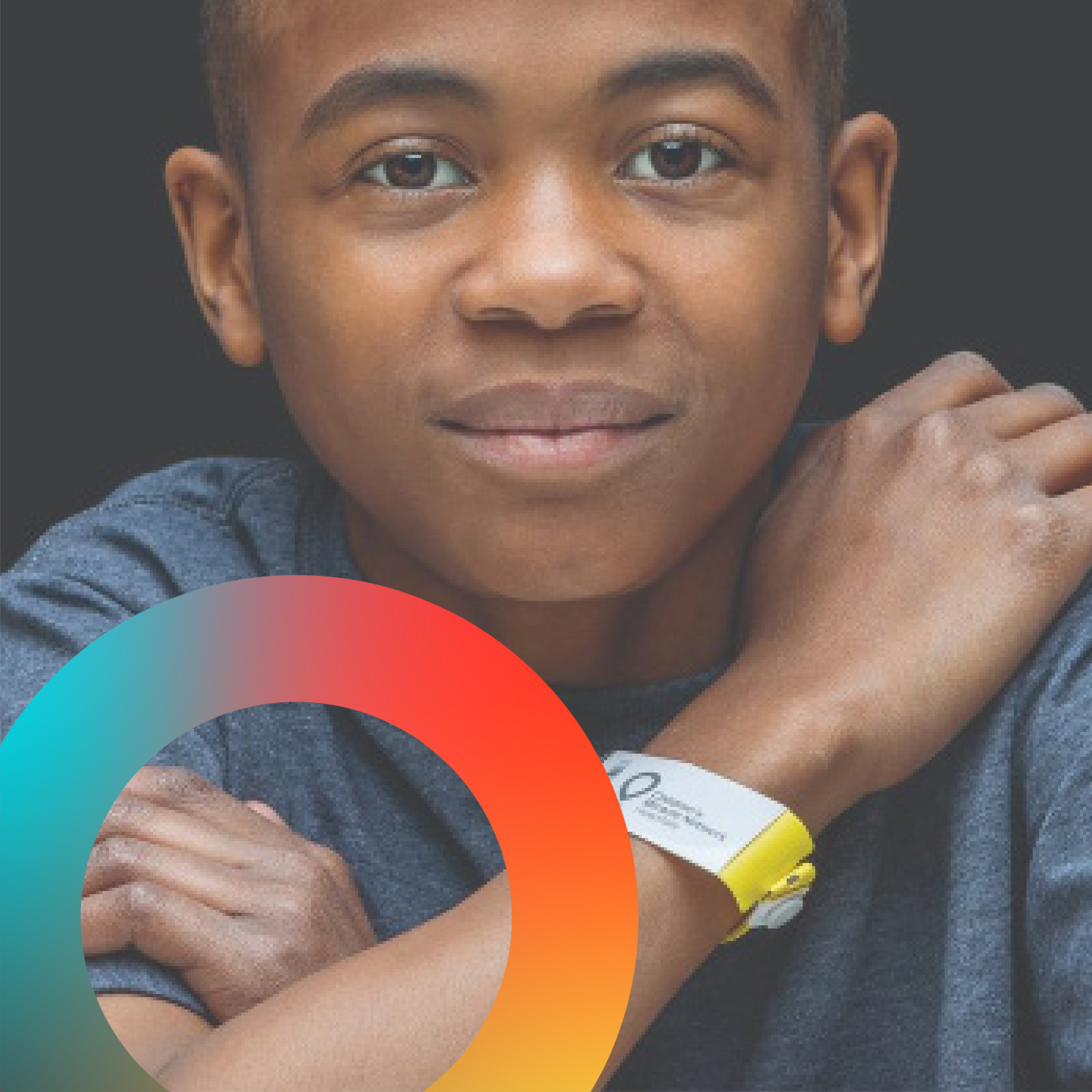 Close-up of a young boy holding yellow highlighters, smiling, with colorful overlaying circles.
