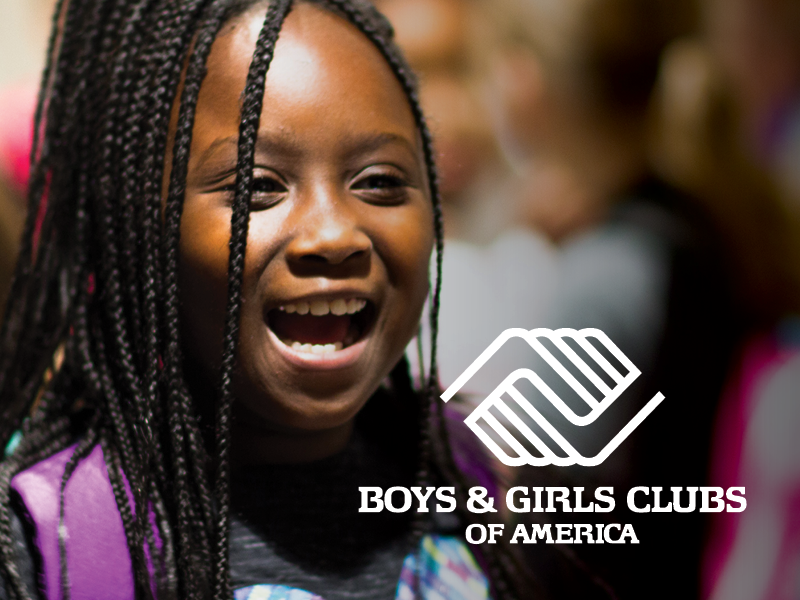 Smiling young girl with braided hair at a Boys & Girls Clubs event.