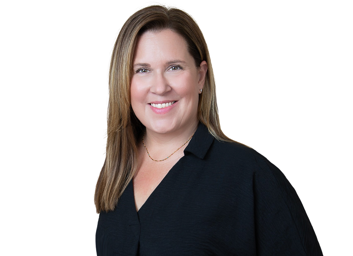 A woman with long light brown hair, smiling, wearing a black shirt and a delicate necklace, against a plain background.