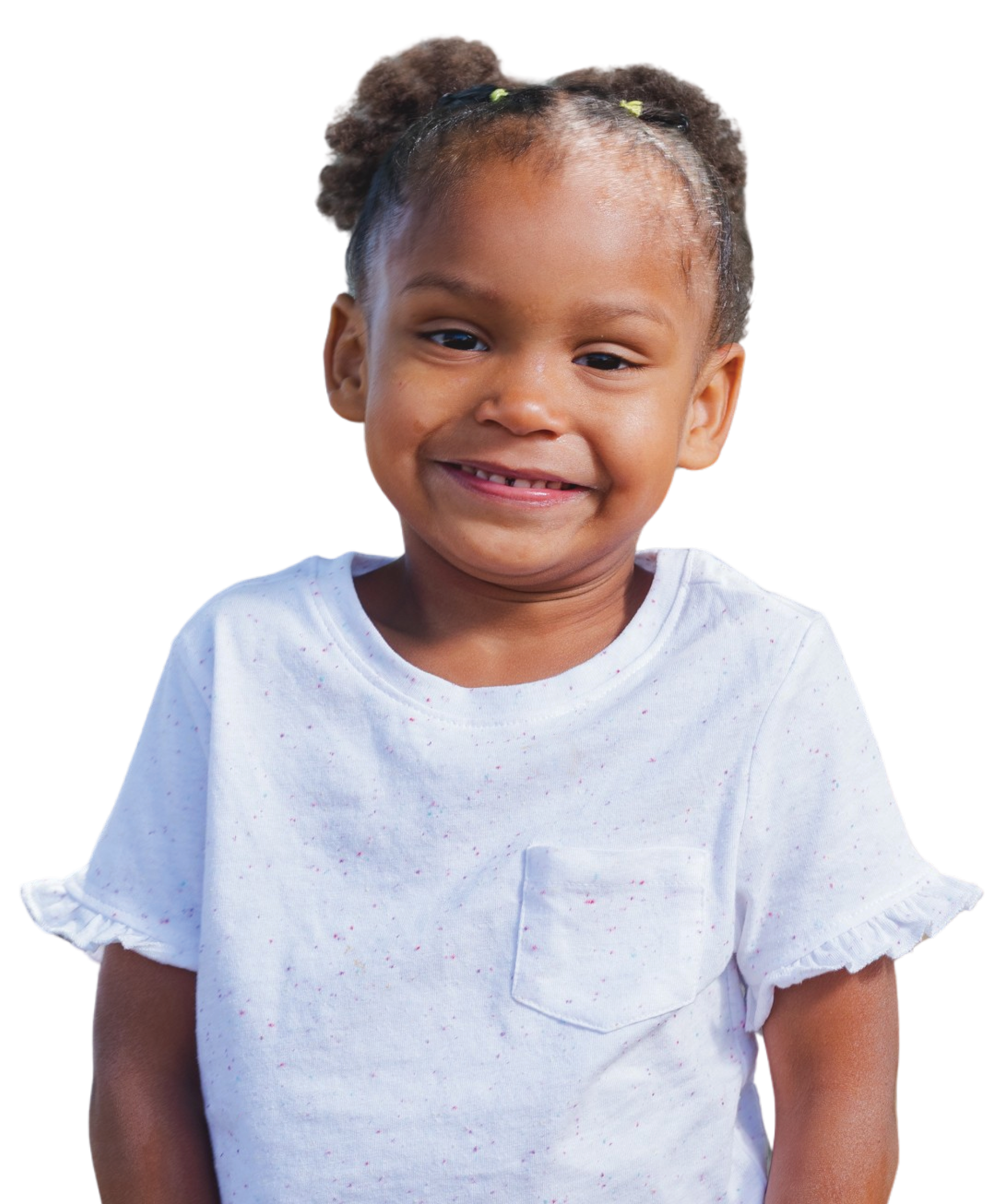 Close-up of a smiling young girl with braided hair styled in two buns, wearing a white shirt with colorful speckles.