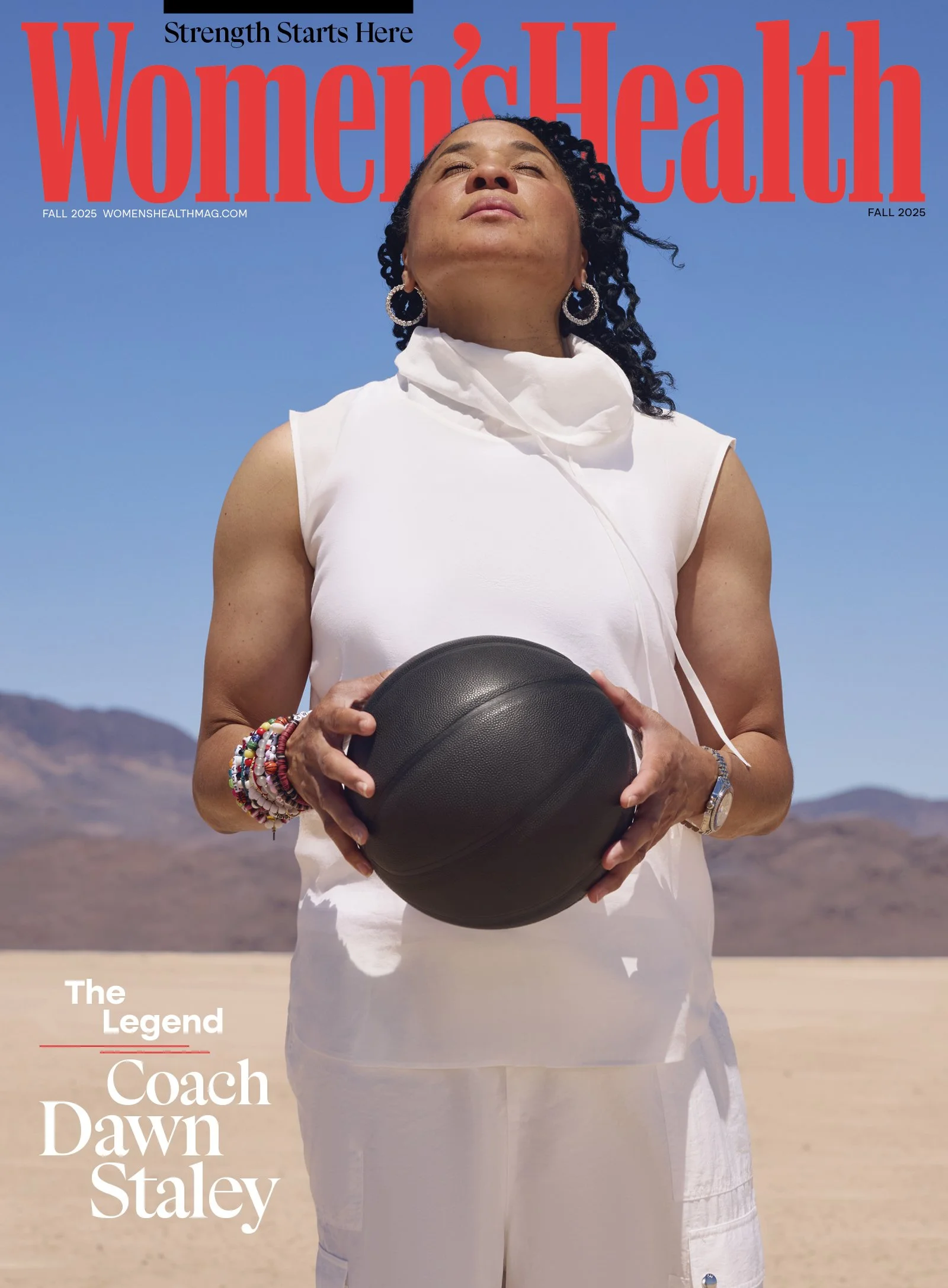 Cover of Women's Health magazine featuring Coach Dawn Staley outdoors in a desert landscape, holding a black basketball, with a clear blue sky, mountains, and the magazine title in red text.