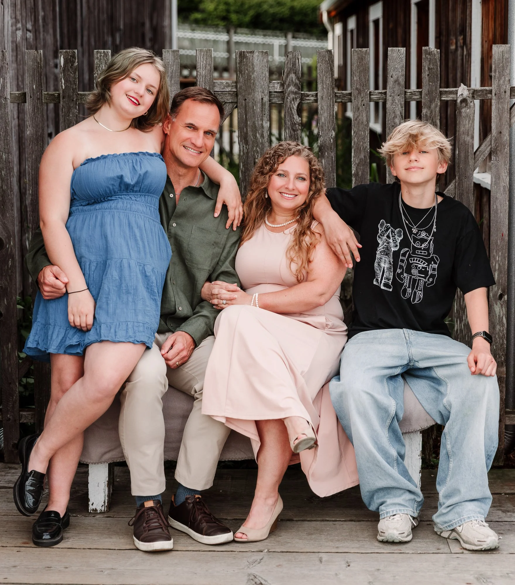 Family smiling at sunset with Richmond family photographer Michelle Baril at Britannia Shipyards.