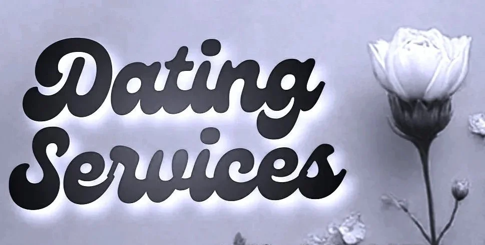 Sign with the words 'Dating Services' in bold black cursive font and a white rose beside it.