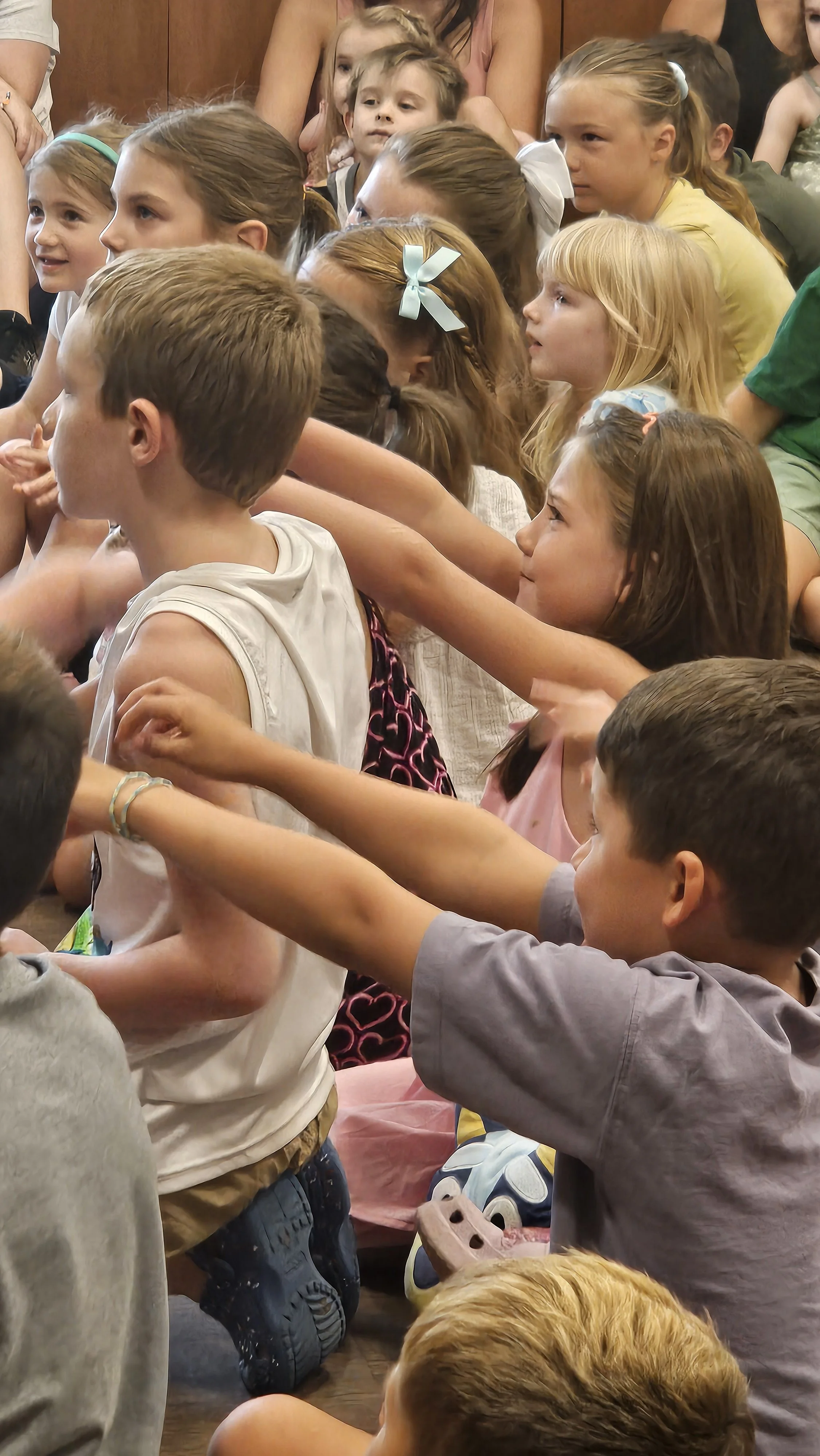 The crowd helps with a magic trick at Magic Fred show