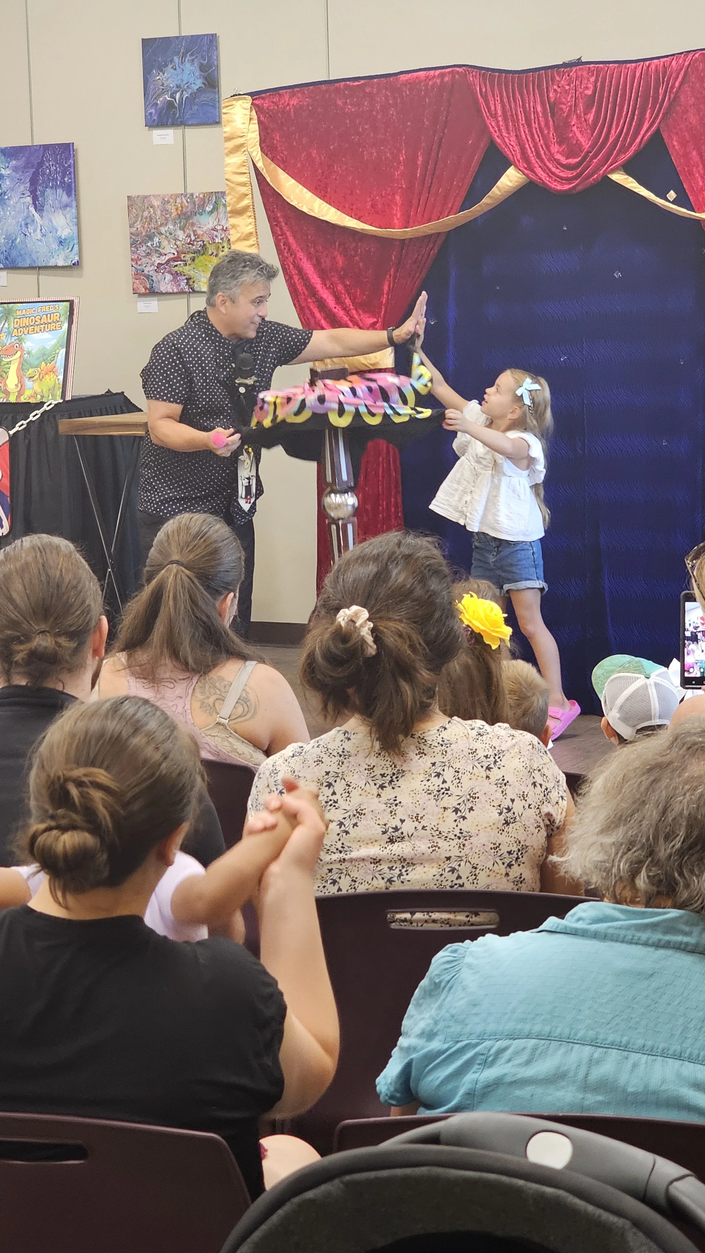 A girl volunteers at the magic fred show