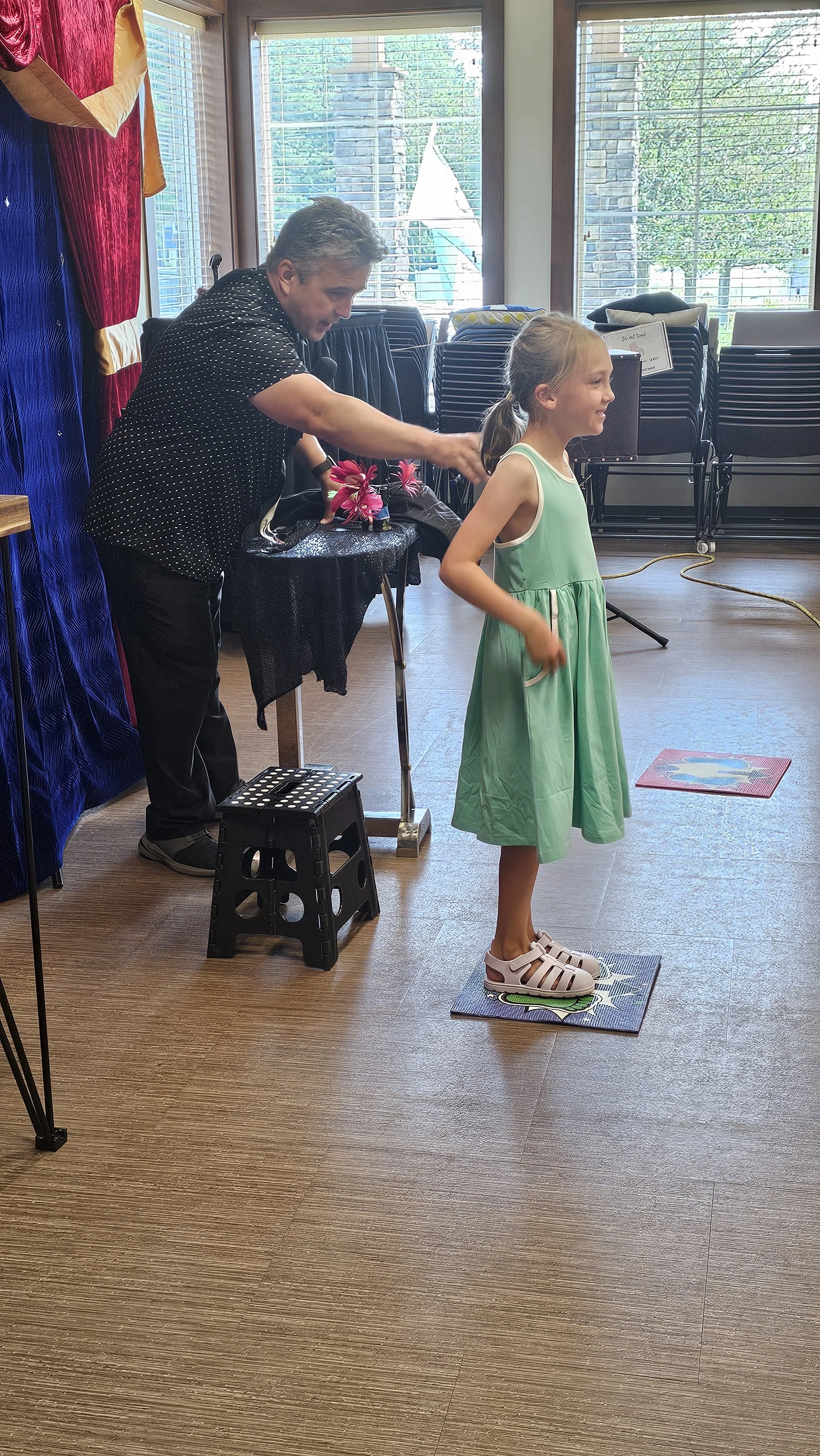 A child volunteers at the Magic Fred show