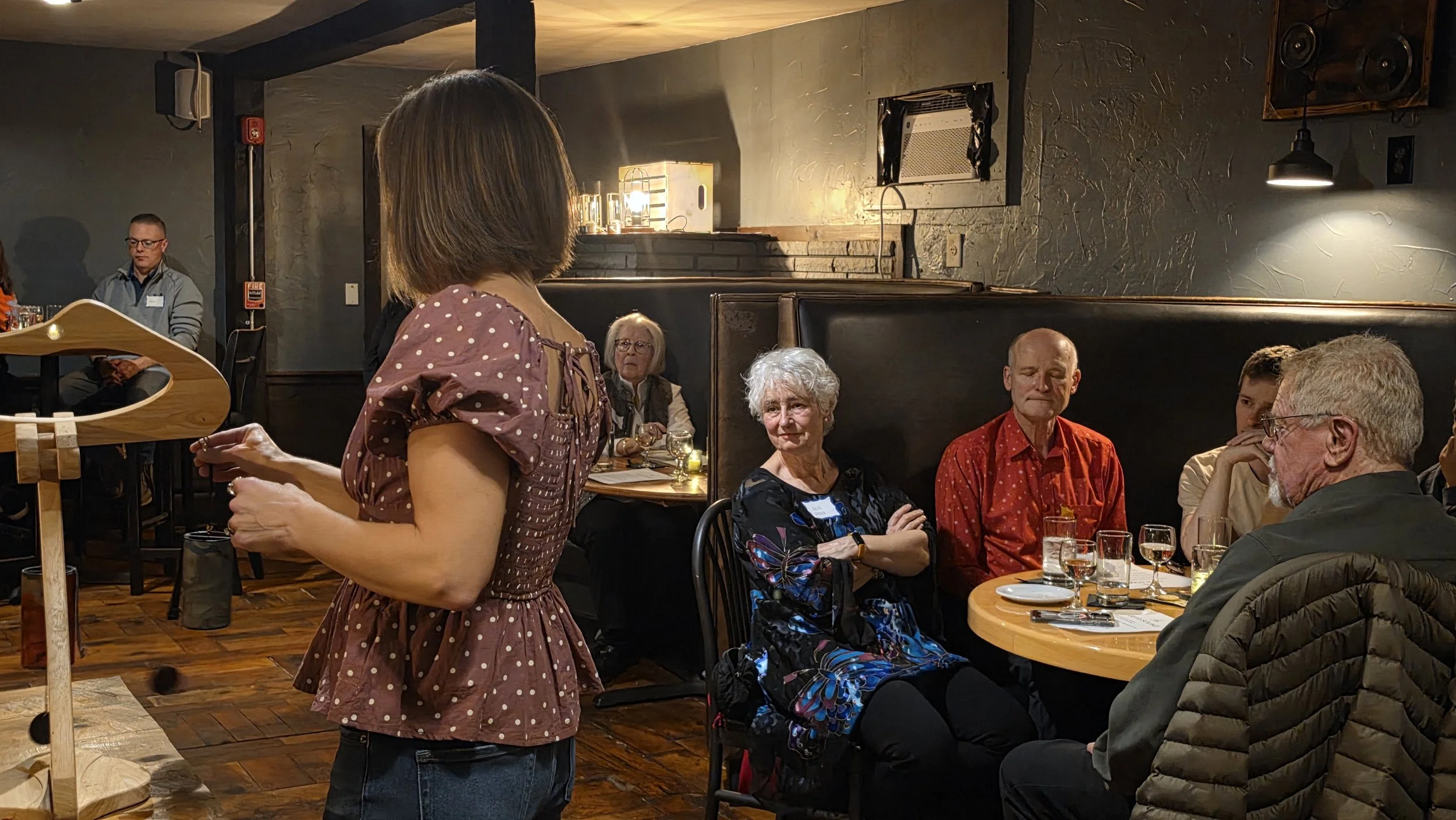 Those seated at tables enjoy Laura's playing