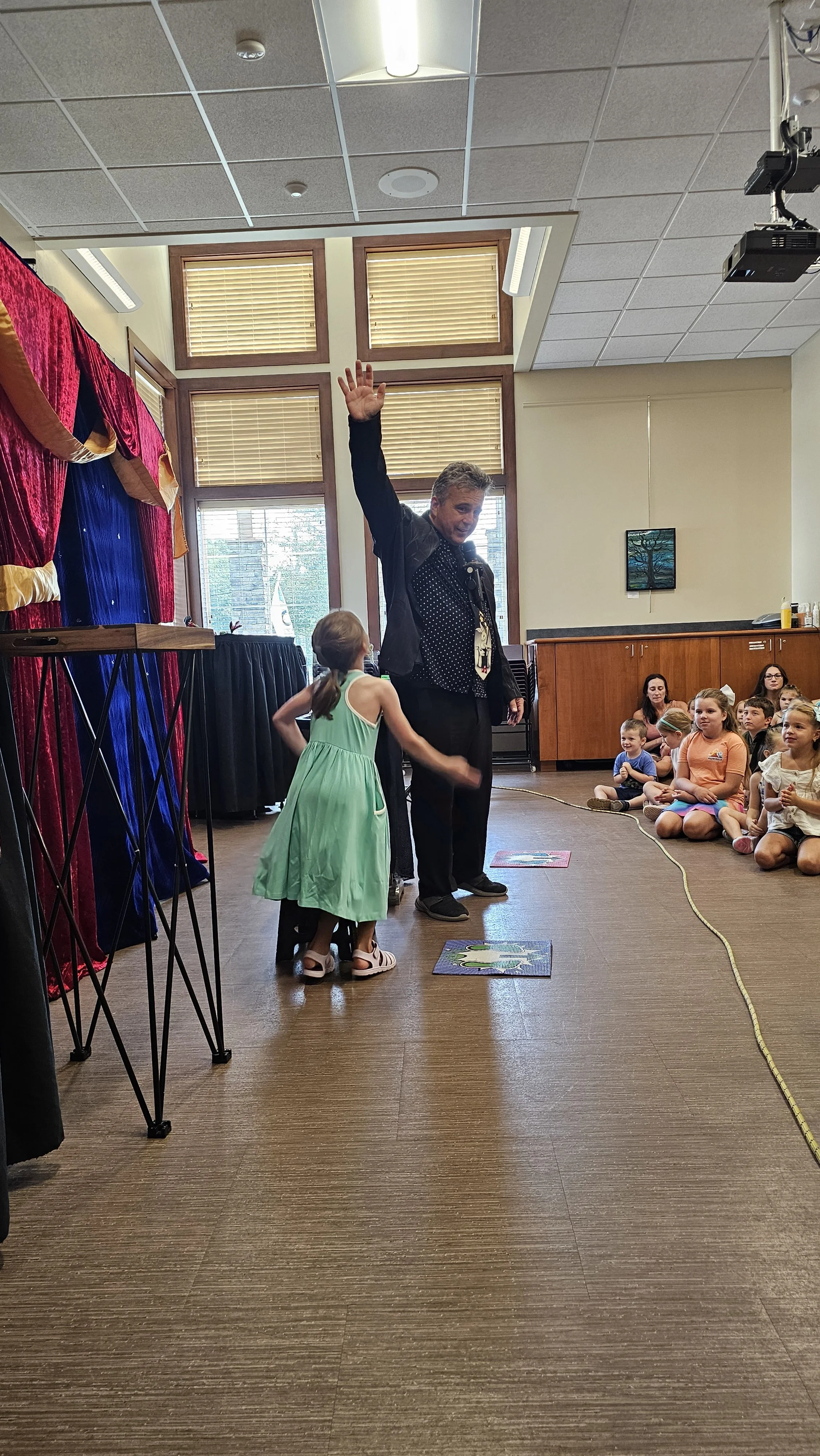 a child volunteers at the Magic Fred show