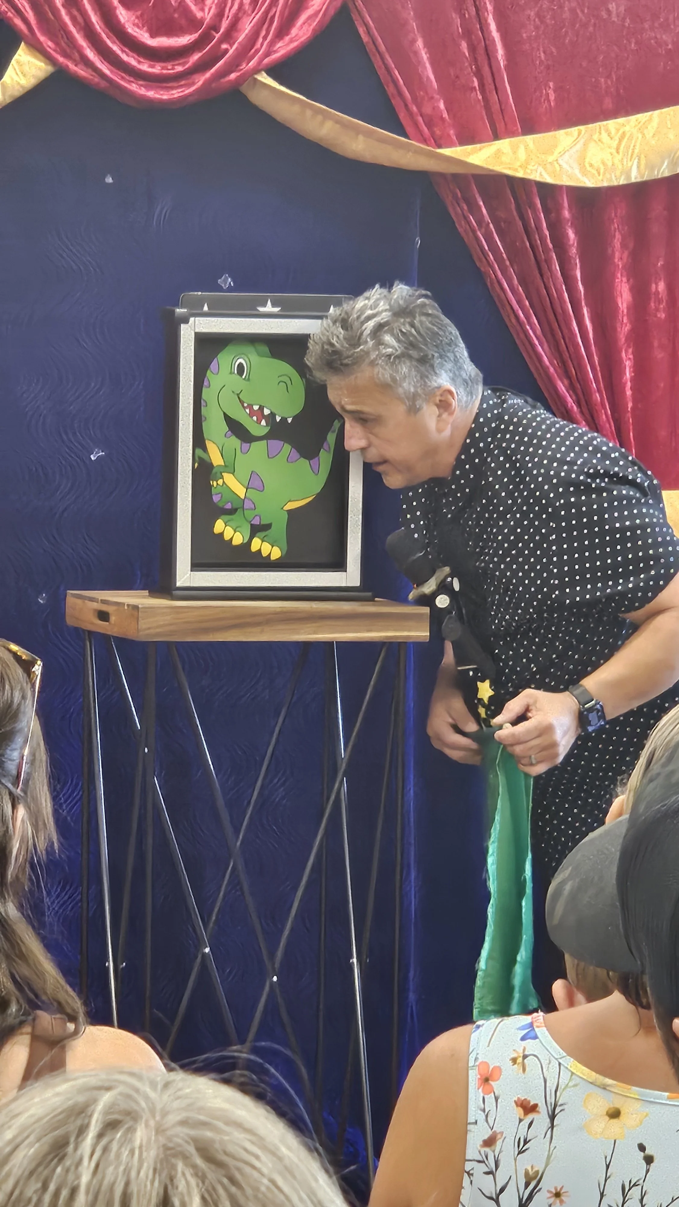 Magic Fred introduces his dinosaur puppets.