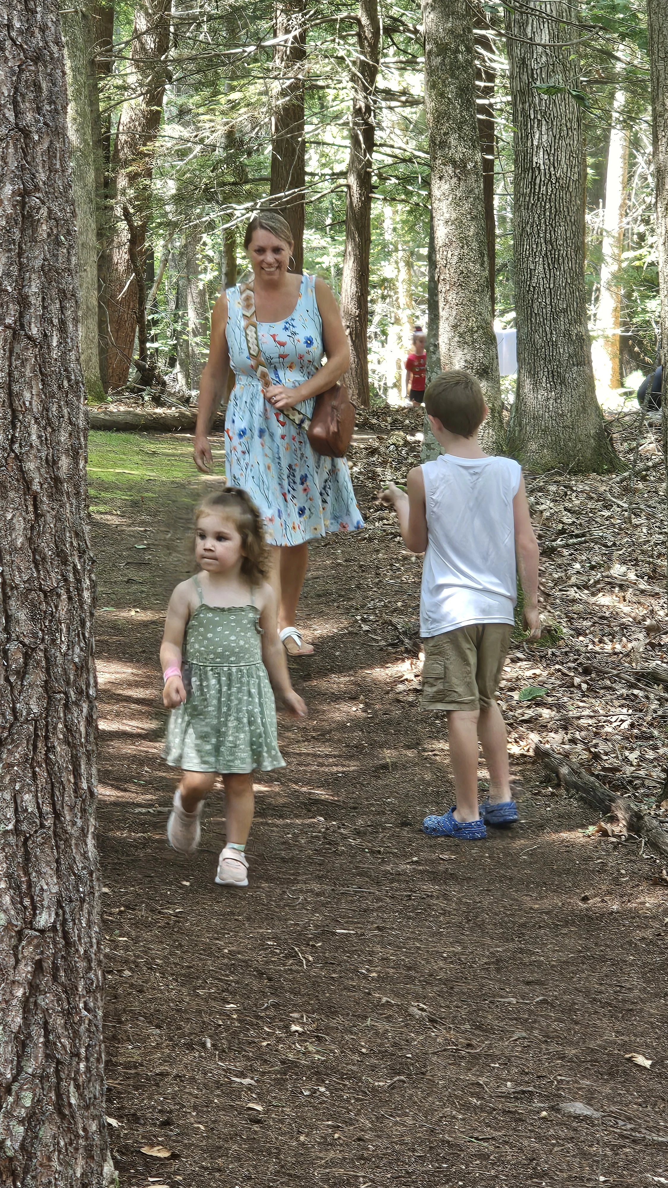 Family enjoys temporary story walk in the woods at KCL
