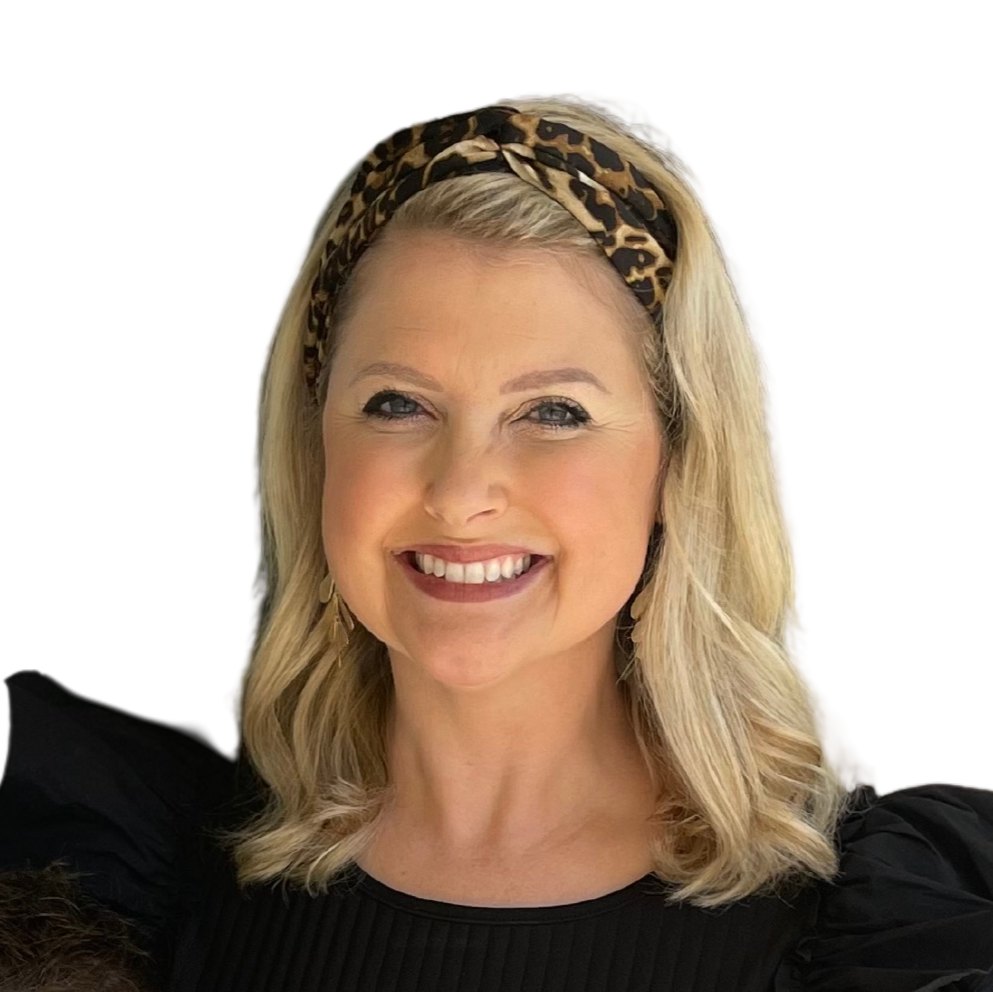 A smiling woman with blonde hair, wearing a black top and a leopard print headband.