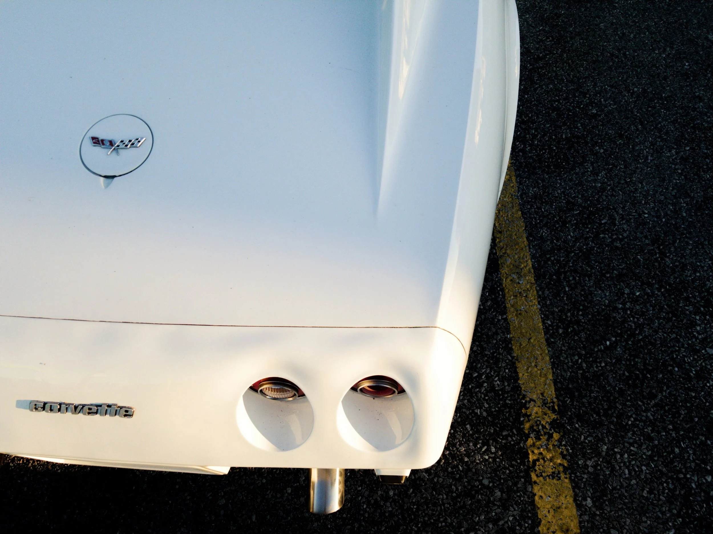 white-corvette-rear-lights-parking-lot.jpeg