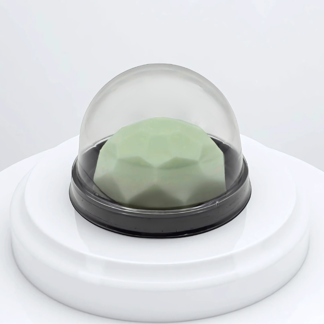 A futuristic object with a geodesic shape, covered by a transparent dome on a white base.