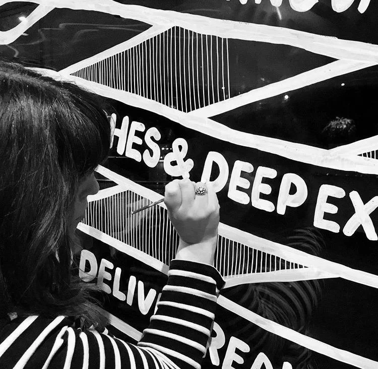 Melbourne Mural Artist Kate Baxter painting on a skyscraper window