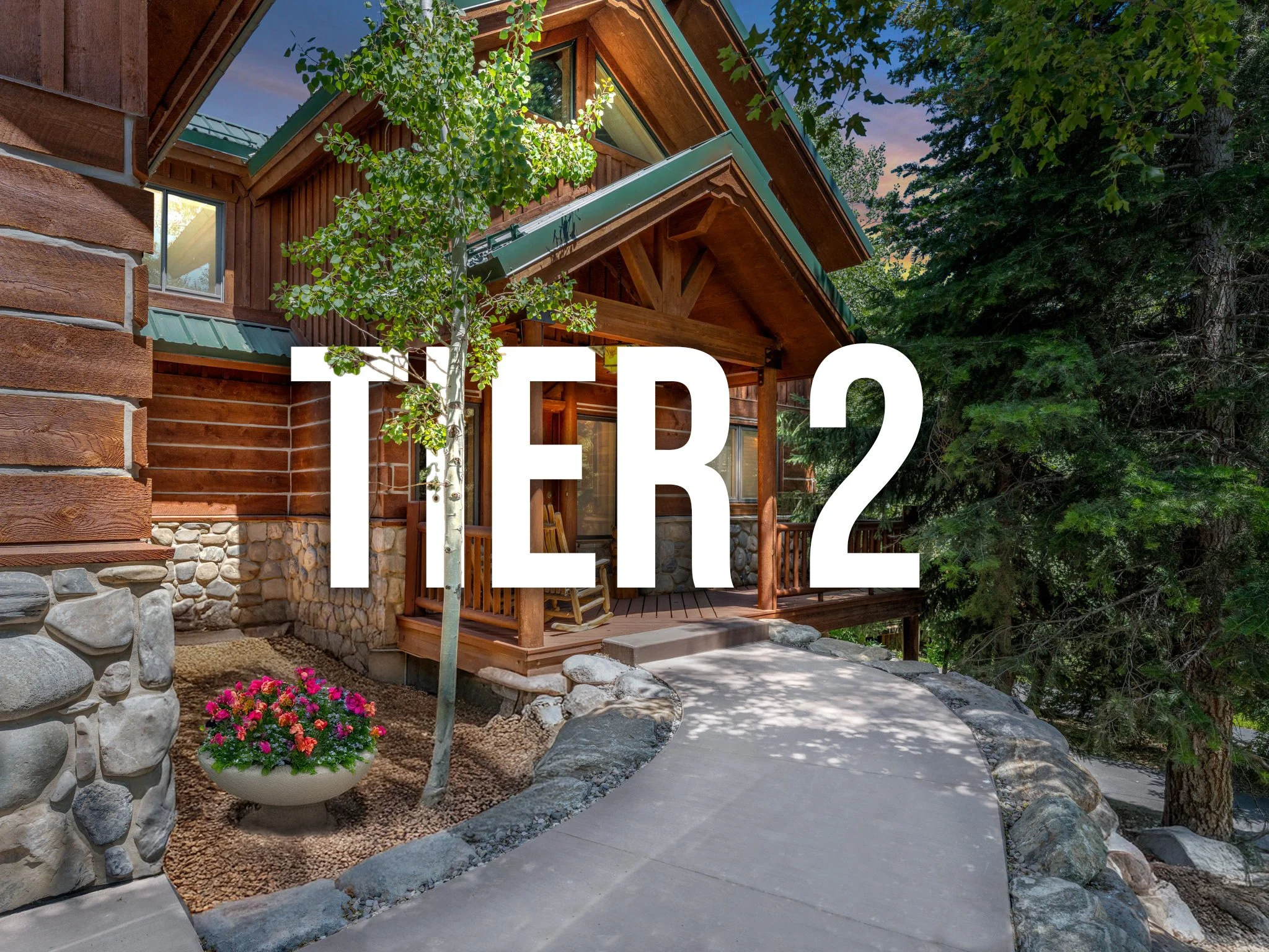 Front porch of a rustic wooden house with a curved concrete walkway, a potted plant with pink flowers, surrounded by trees and greenery, with the word 'TER2' overlaid in large white text.