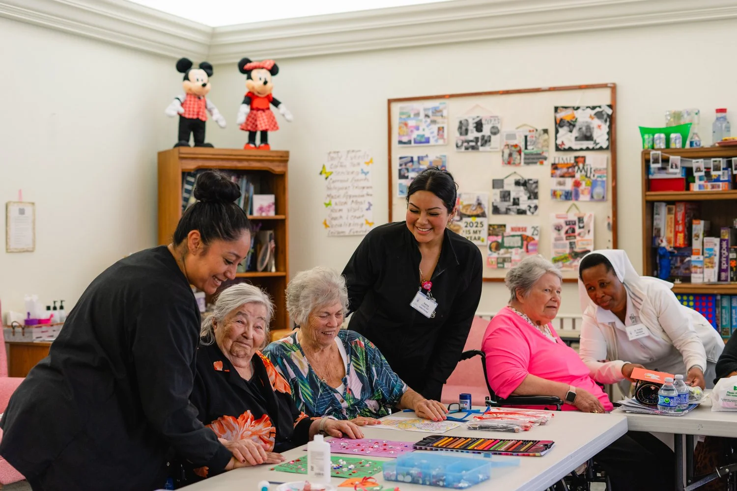 Senior Living craft activities, assisted by staff members.