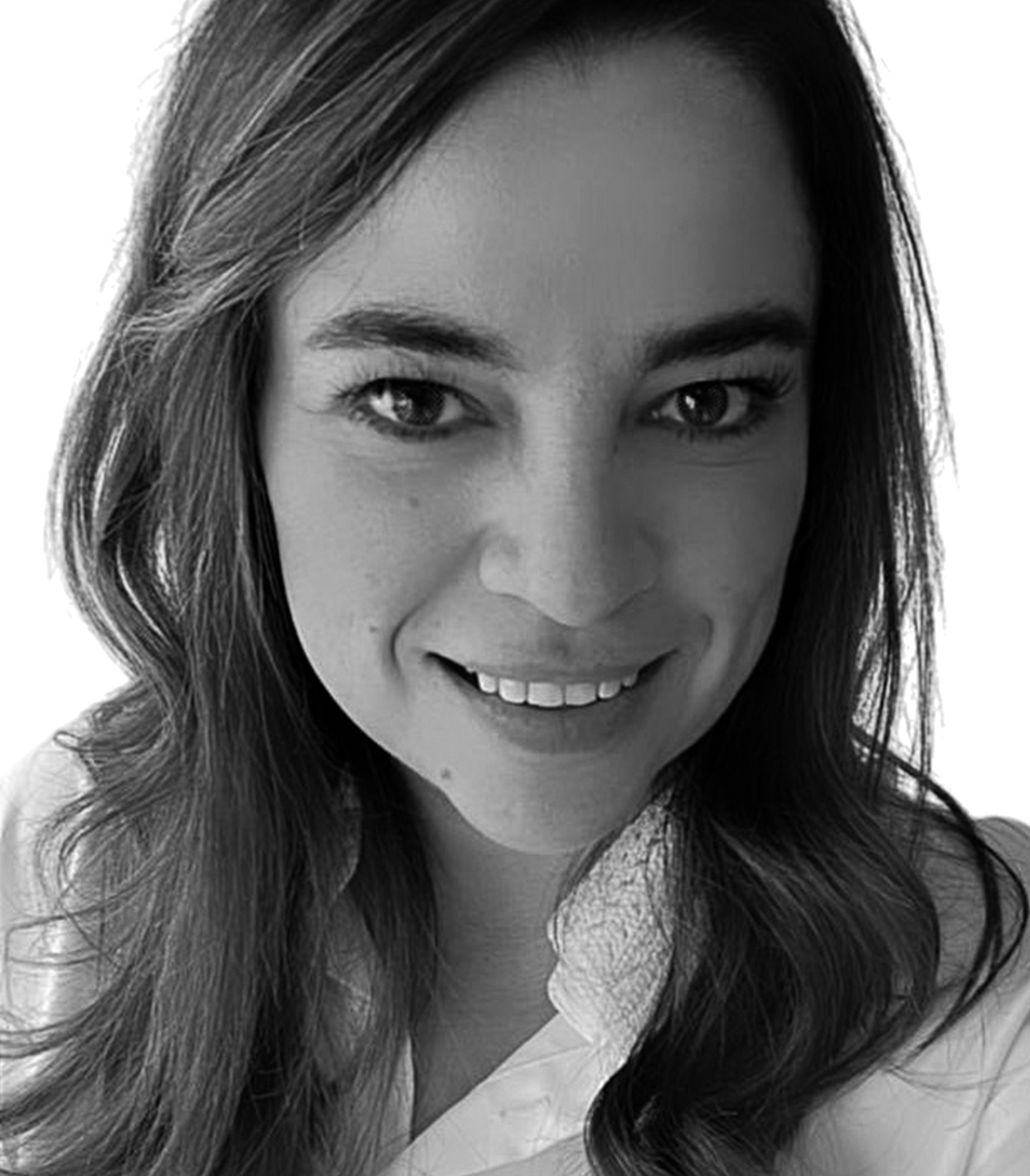 Black and white close-up photograph of a woman with curly hair, smiling, wearing a collared shirt.