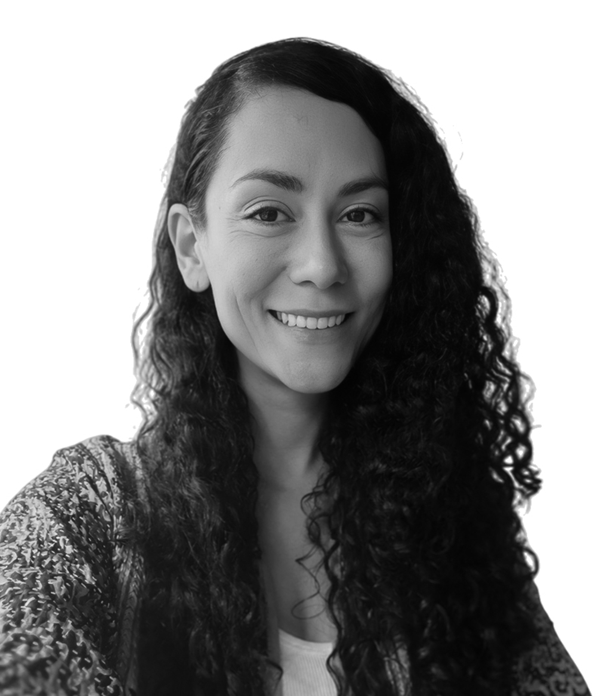 Black and white portrait of a smiling woman with curly hair, wearing a patterned top.