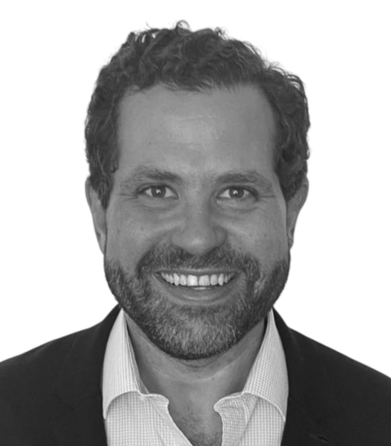 Black and white portrait of a smiling man with curly hair, a beard, wearing a collared shirt and blazer.