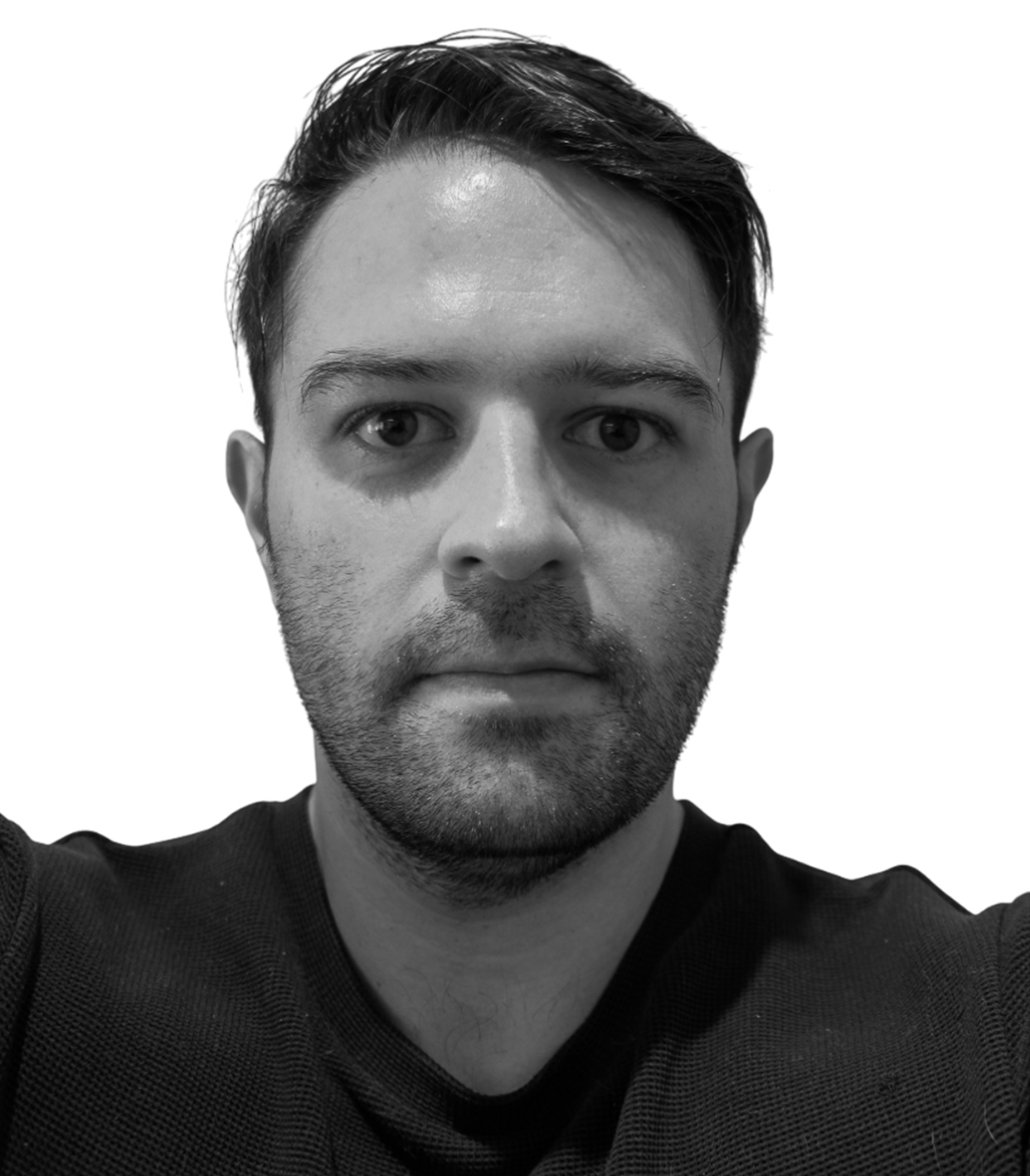 Black and white close-up of a young man with short, dark hair, slight stubble, and wearing a dark shirt, against a plain background.