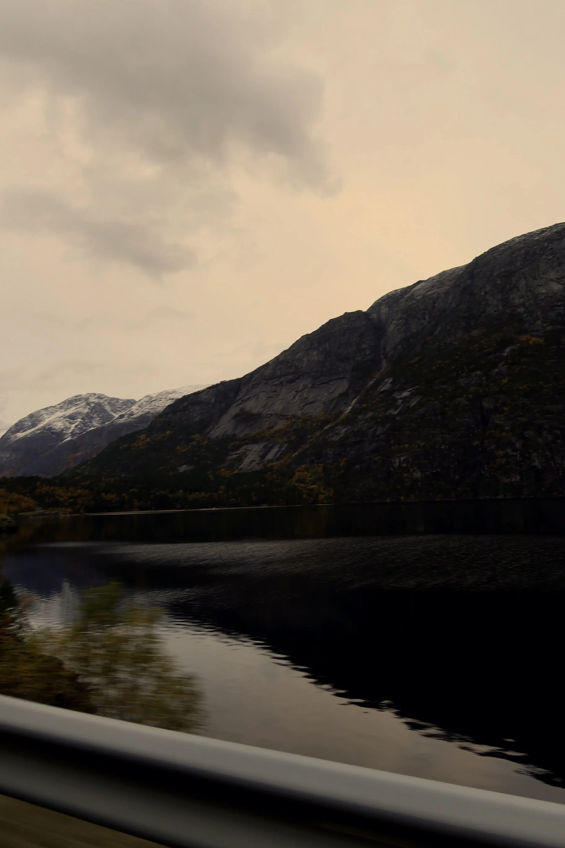 Mountain lake with snow-capped peaks and cloudy sky