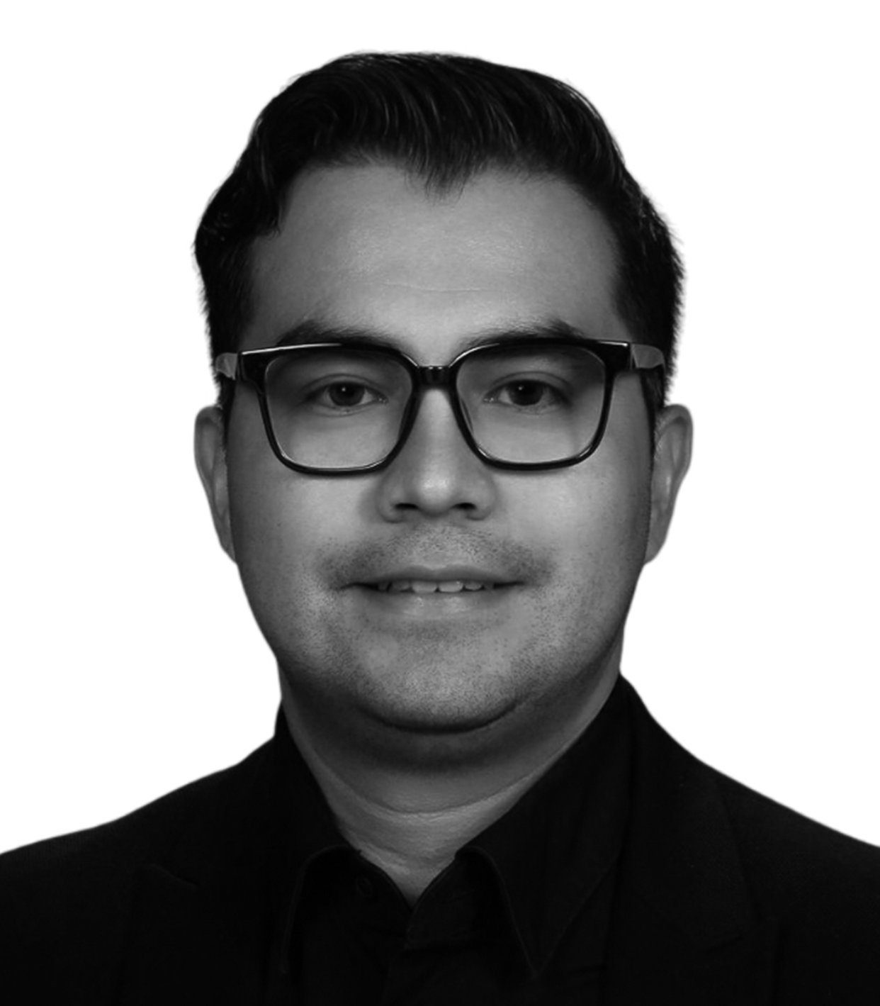 Black and white professional portrait of a man wearing glasses, a black collared shirt, and a blazer, smiling slightly with a neutral expression.